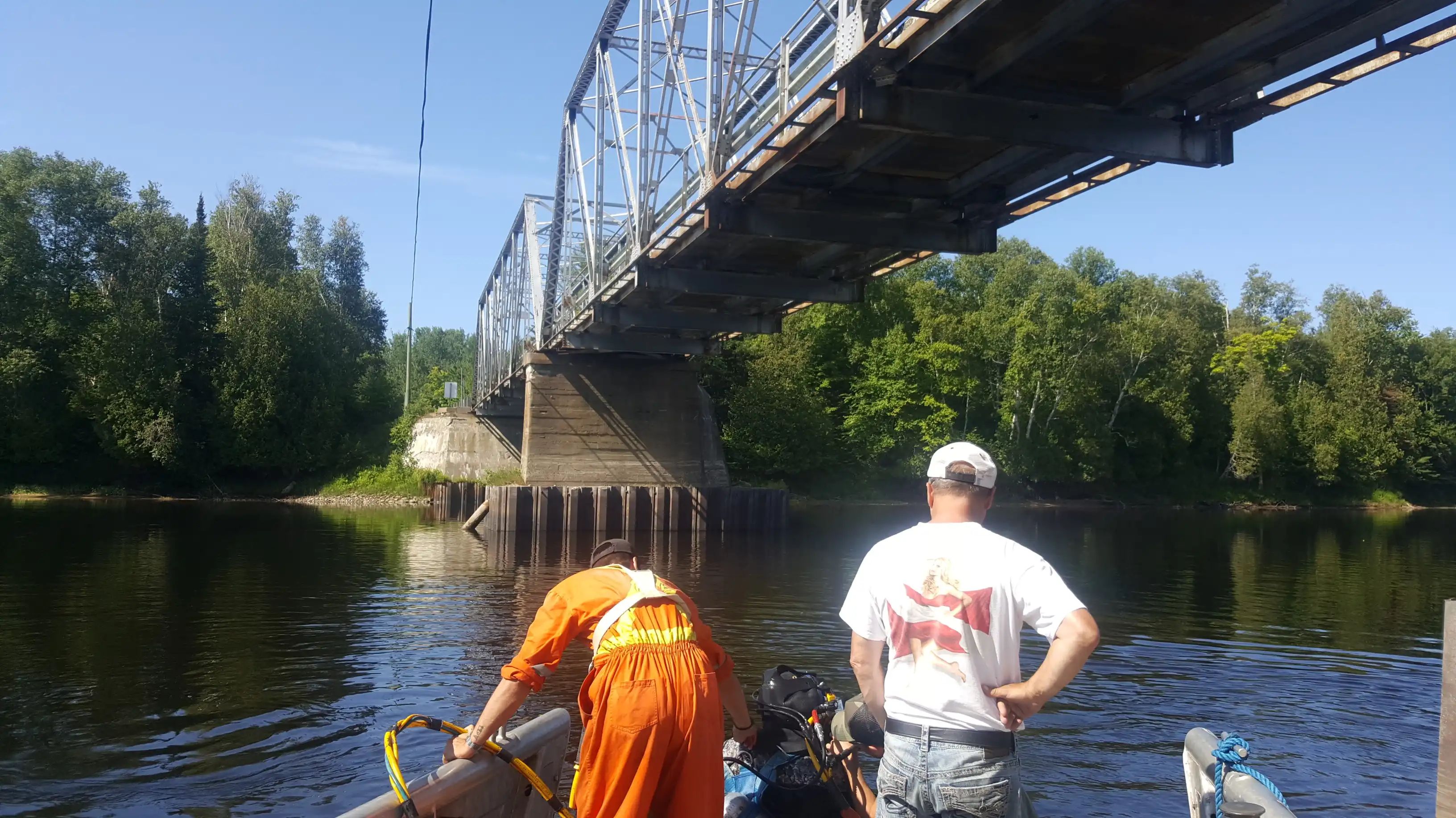 TULLOCH field staff reviewing a municipal bridge over a waterway.