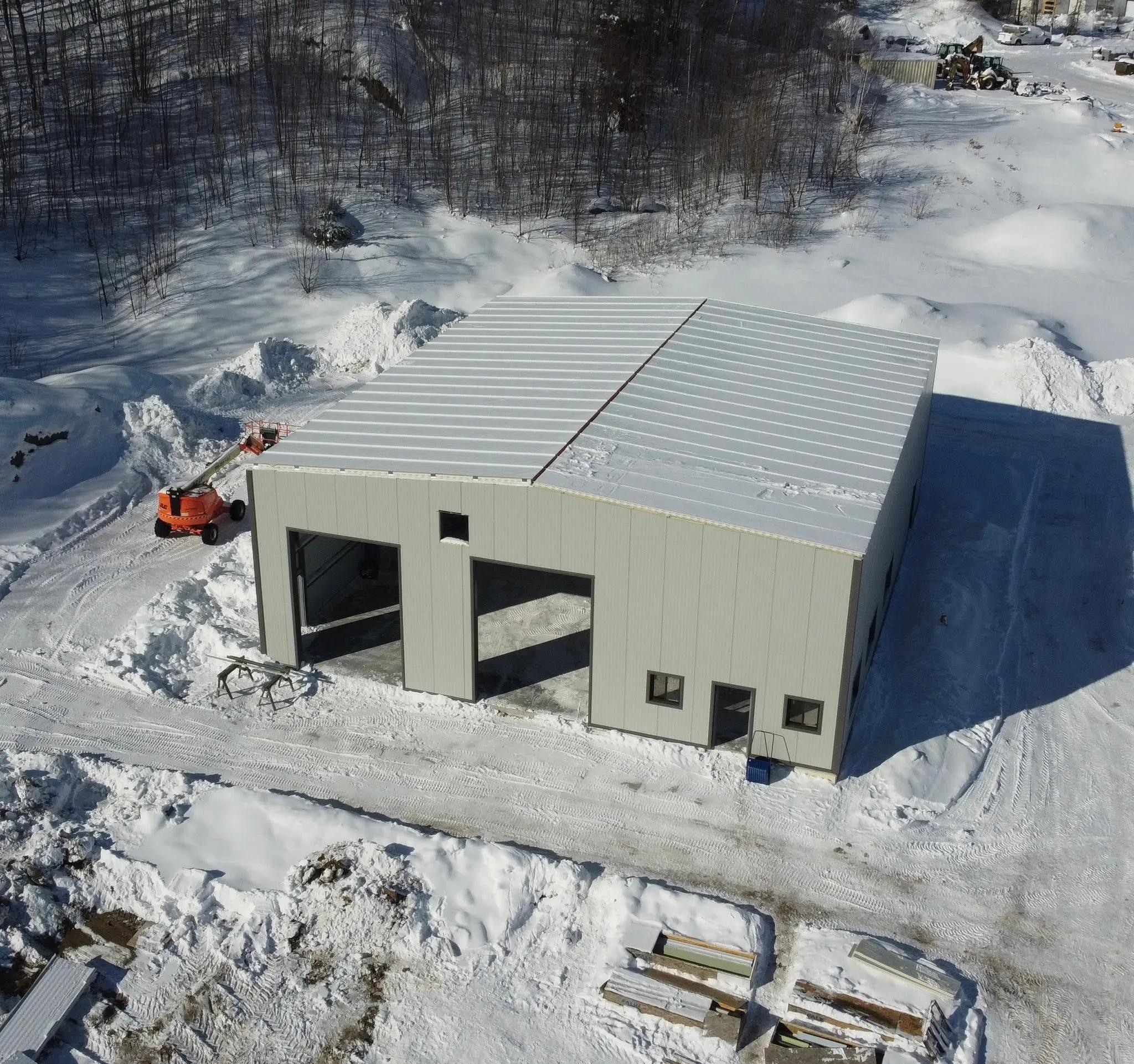 Aerial view of a new industrial or municipal building during winter construction.