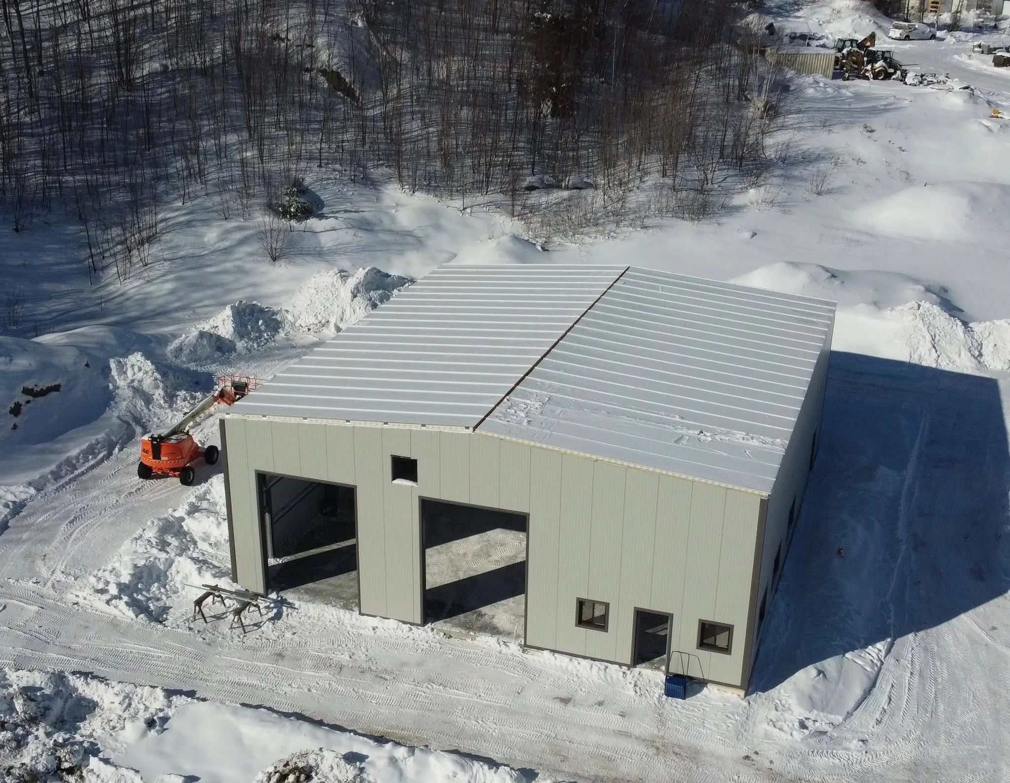 Aerial view of a new industrial or municipal building during winter construction.