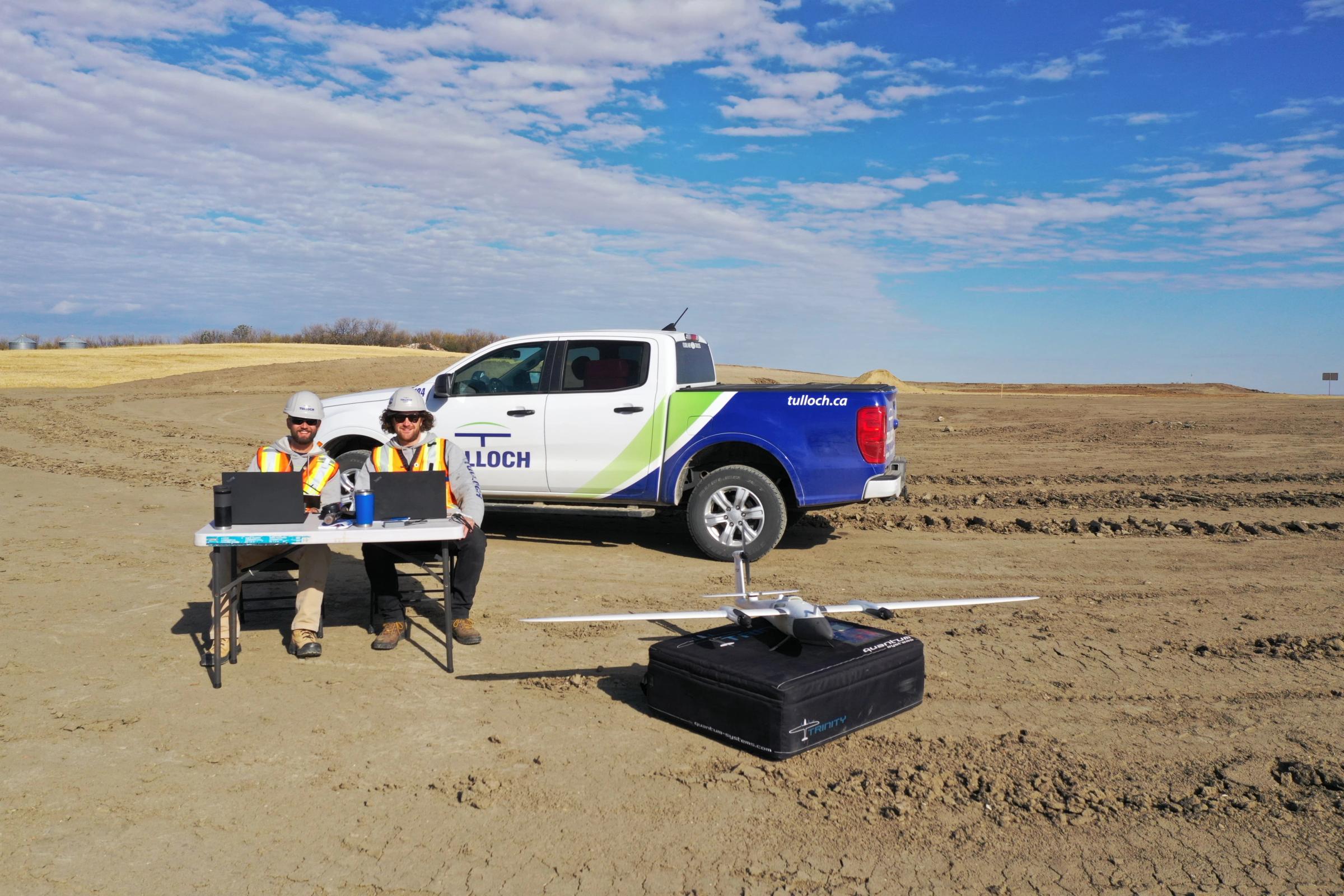 TULLOCH field crew working beside a company truck at the Forty Mile wind project.