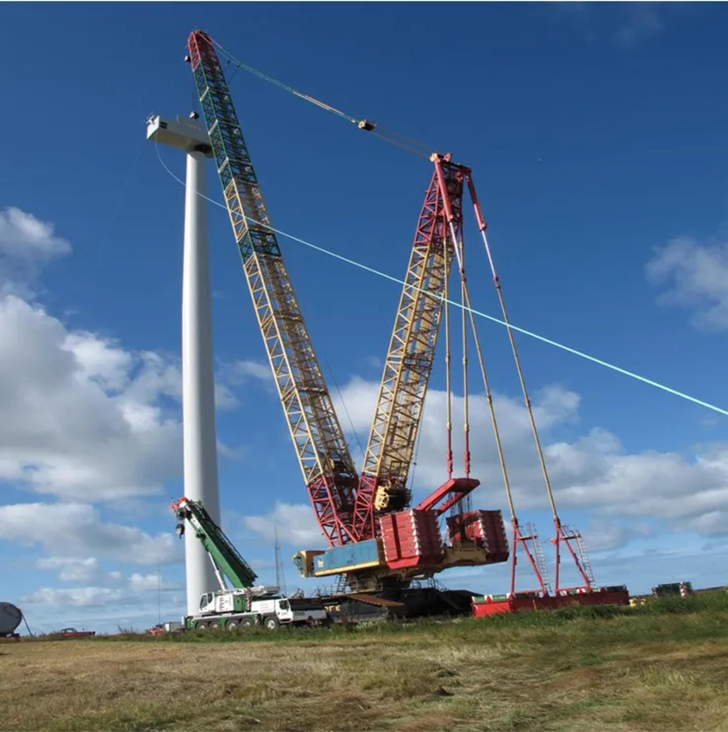Crane erecting a wind turbine tower at a wind energy project.