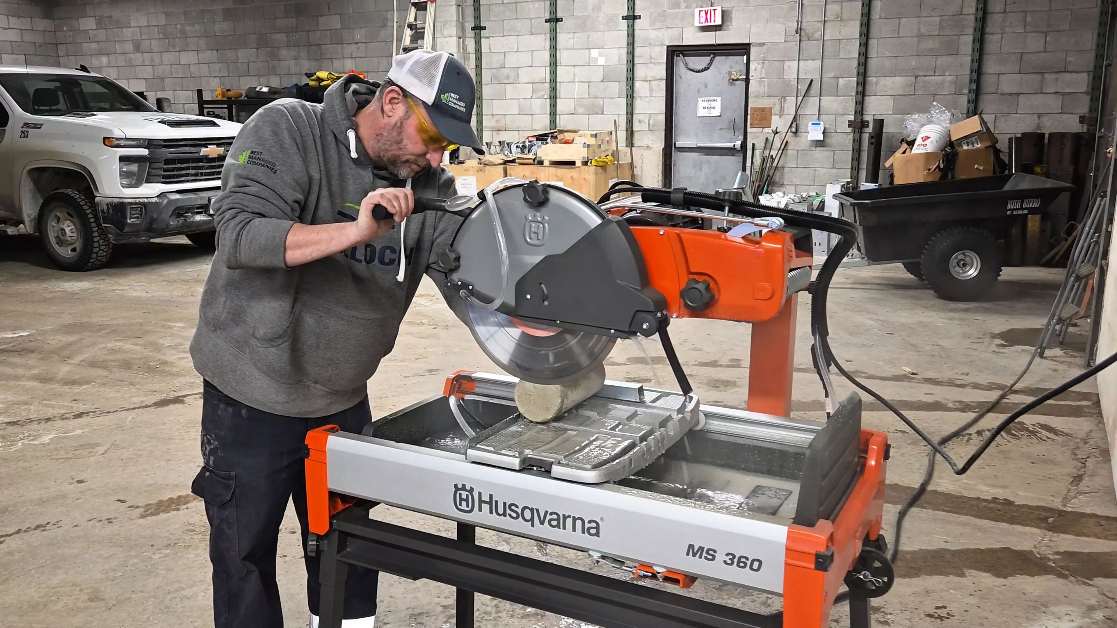 TULLOCH laboratory technician preparing a material sample using a cutting saw