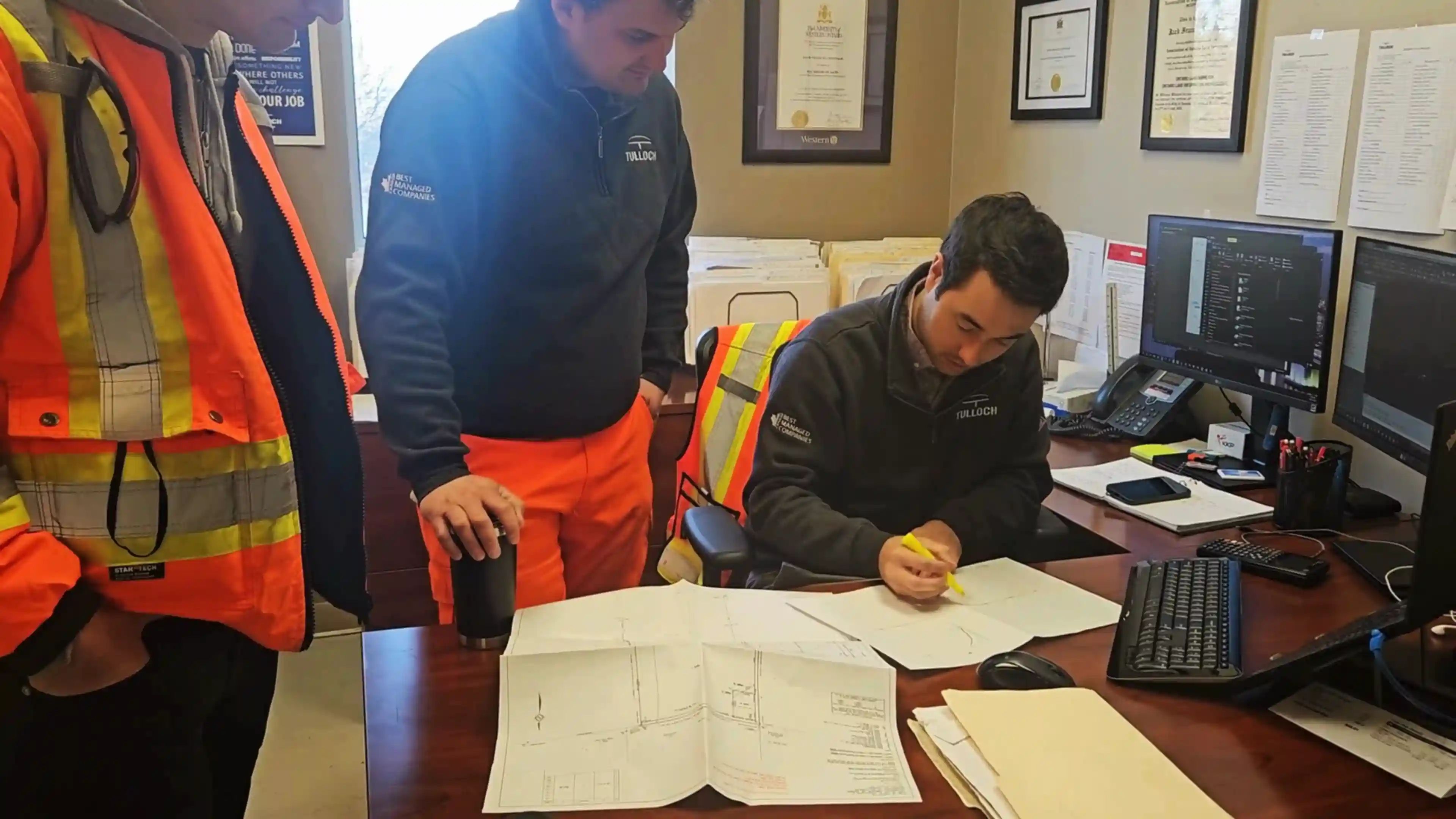 TULLOCH team members reviewing drawings for the Vaughan Mainline Expansion project.