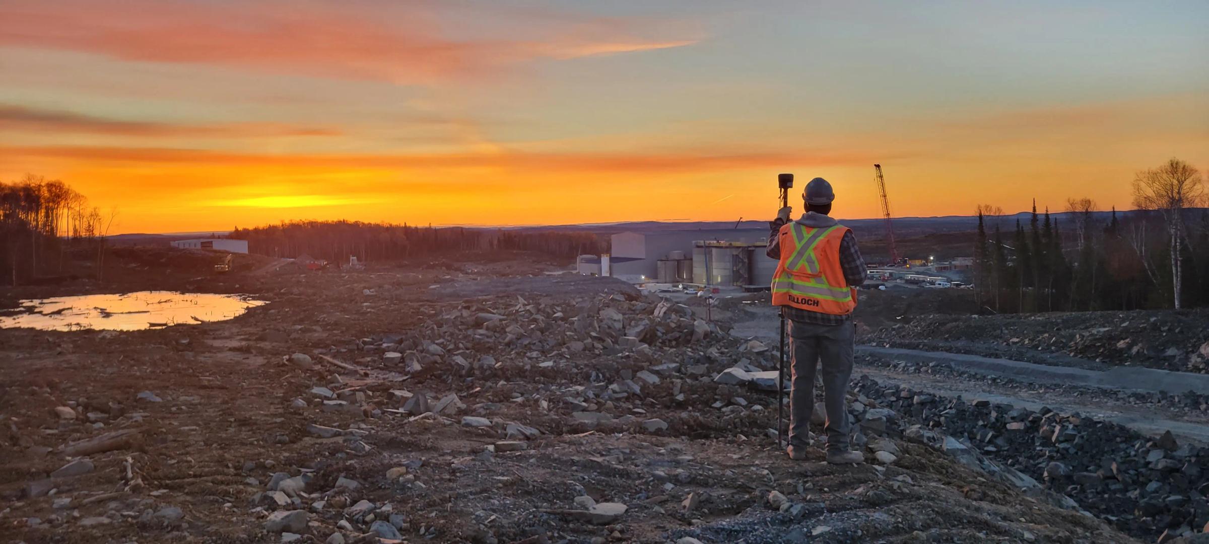TULLOCH surveyor collecting field data at the Magino Gold project at sunset.