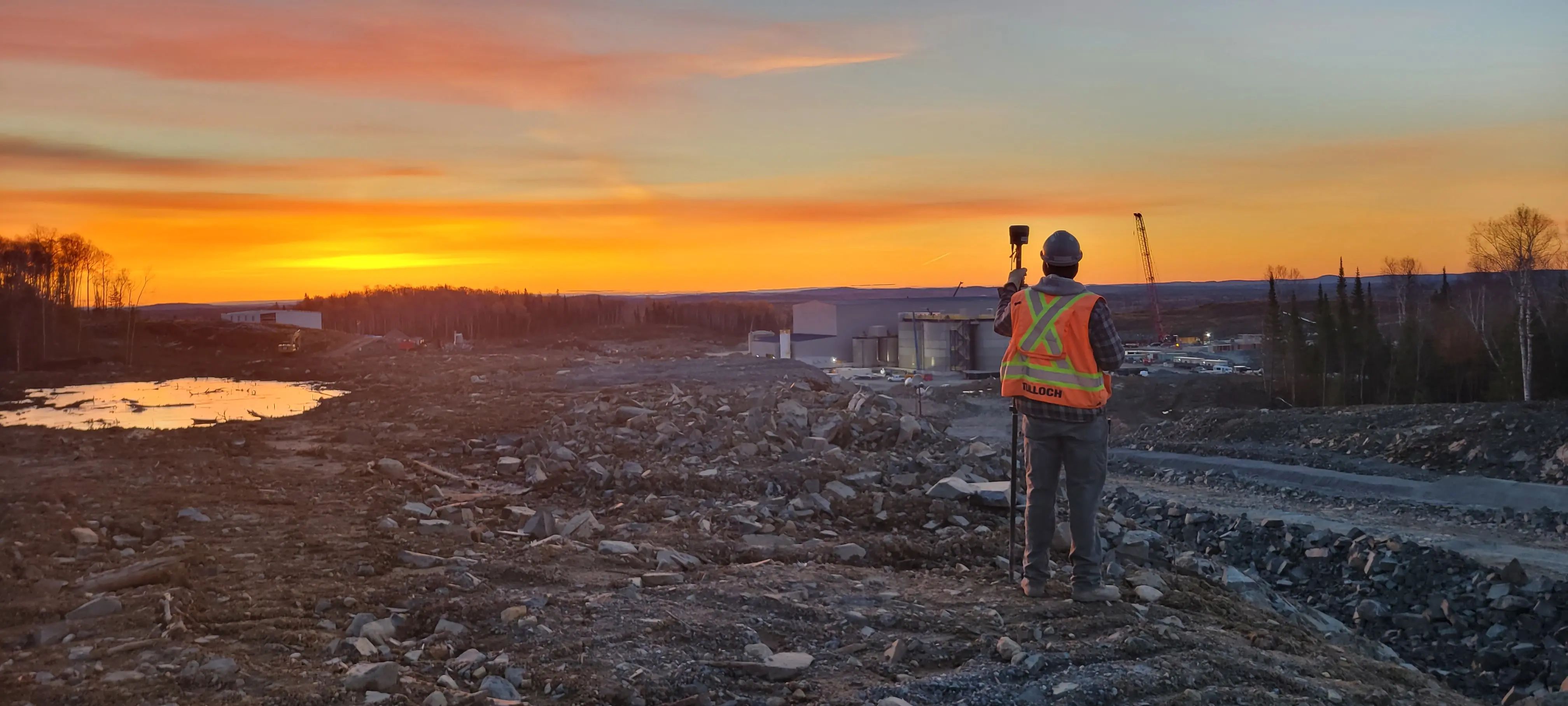 TULLOCH surveyor collecting field data at the Magino Gold project at sunset.