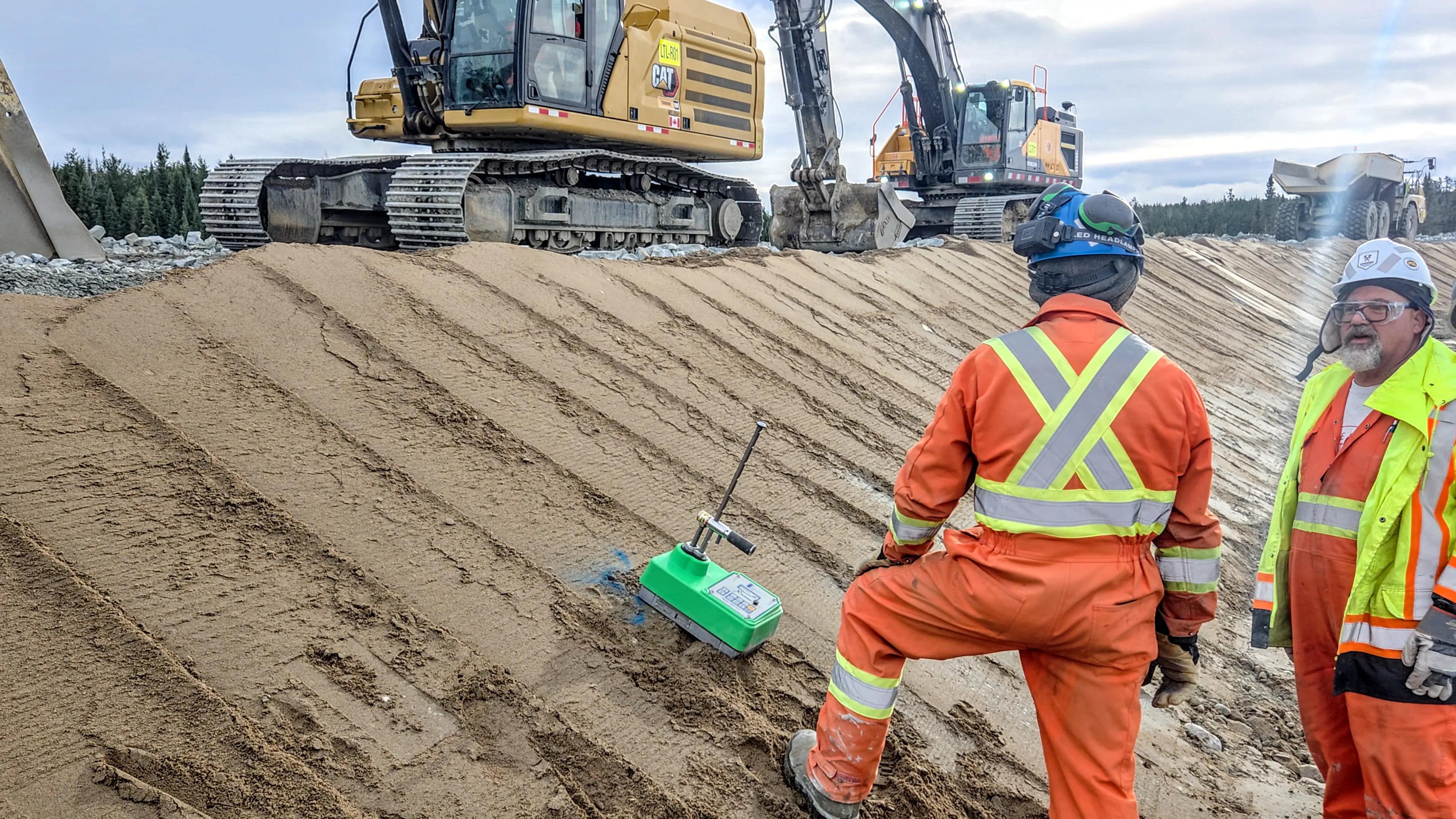 TULLOCH materials testing technicians completing field density testing near earthworks.