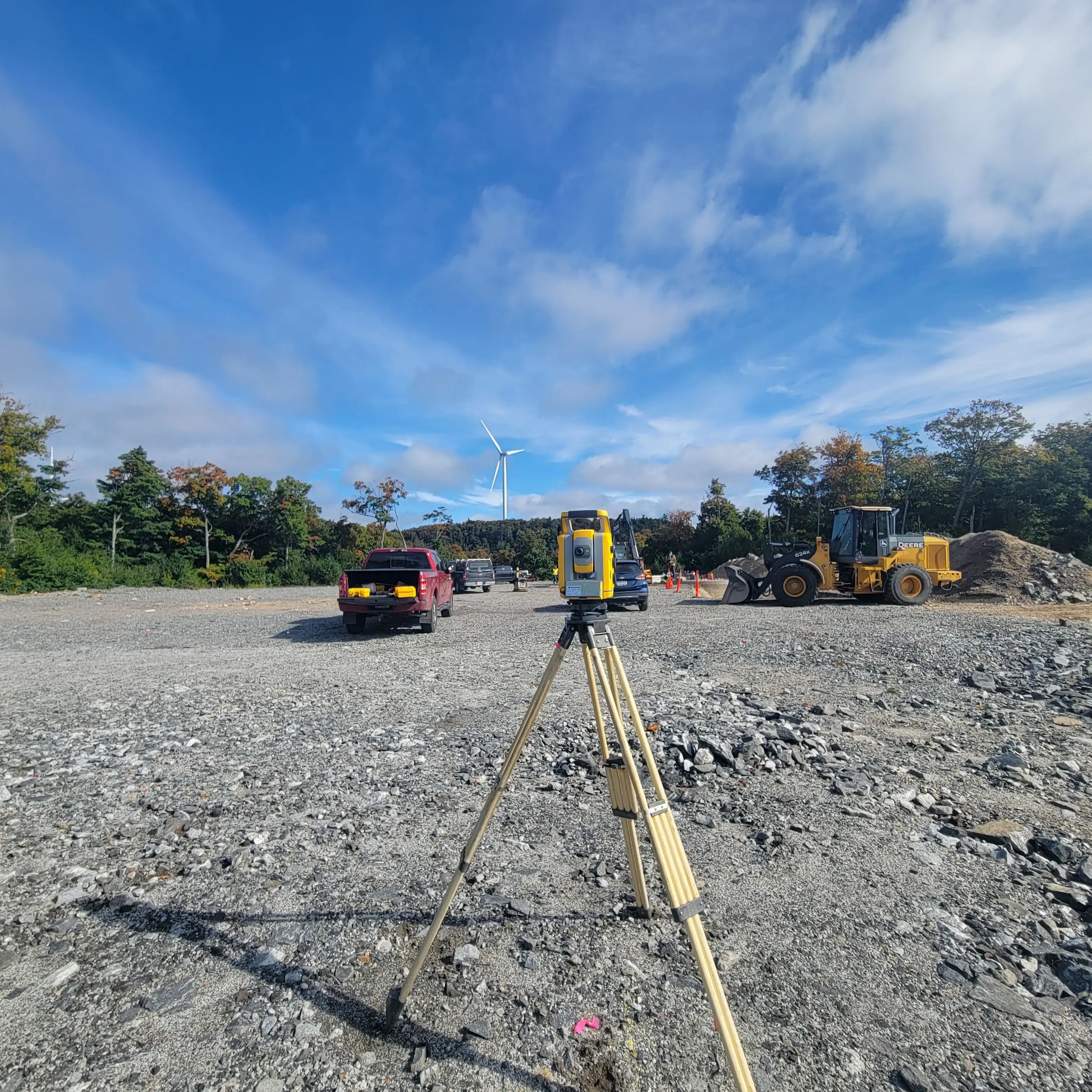 Survey layout lines and equipment at an active construction site.