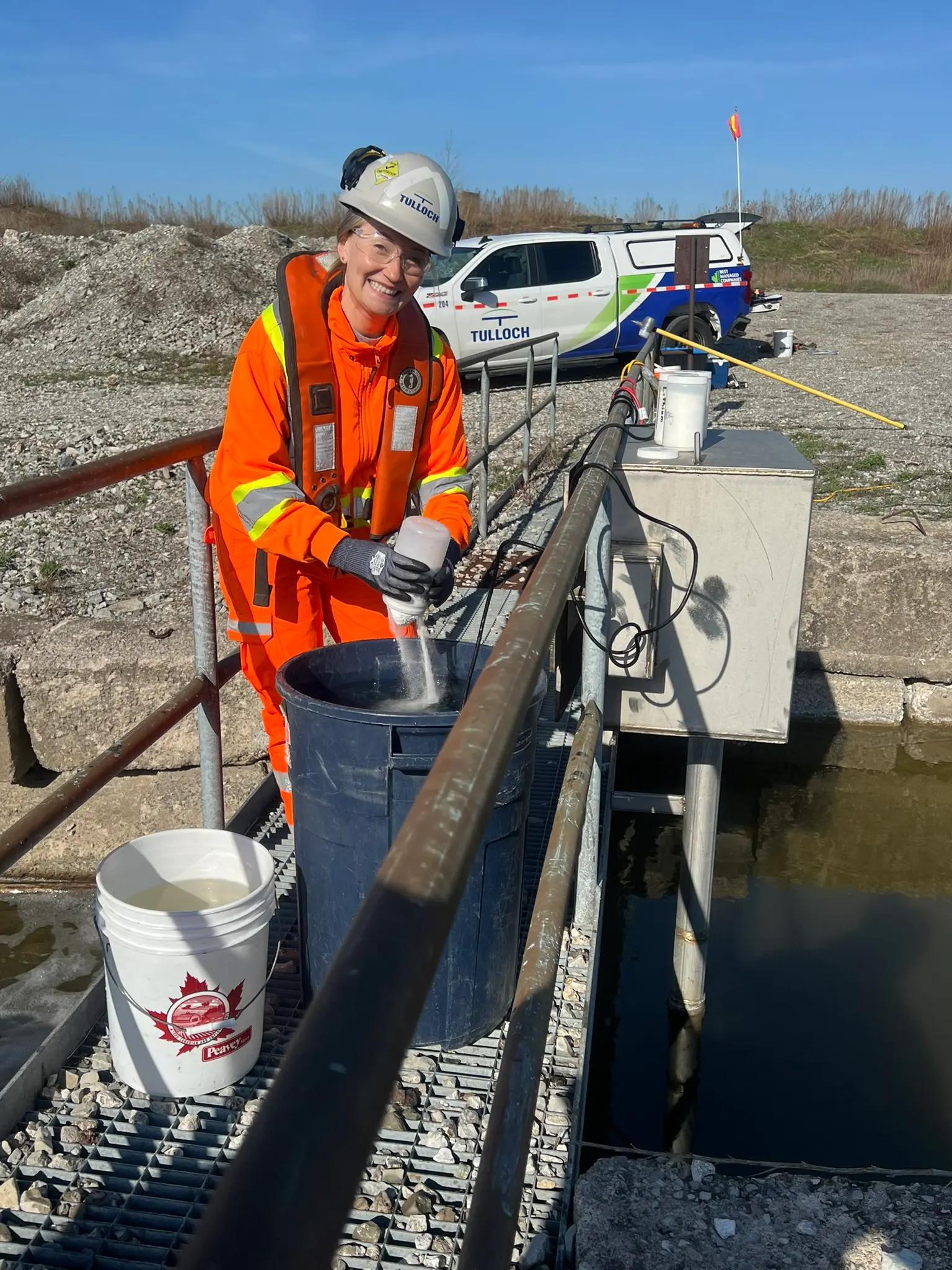 TULLOCH environmental field technician preparing equipment from a boat.