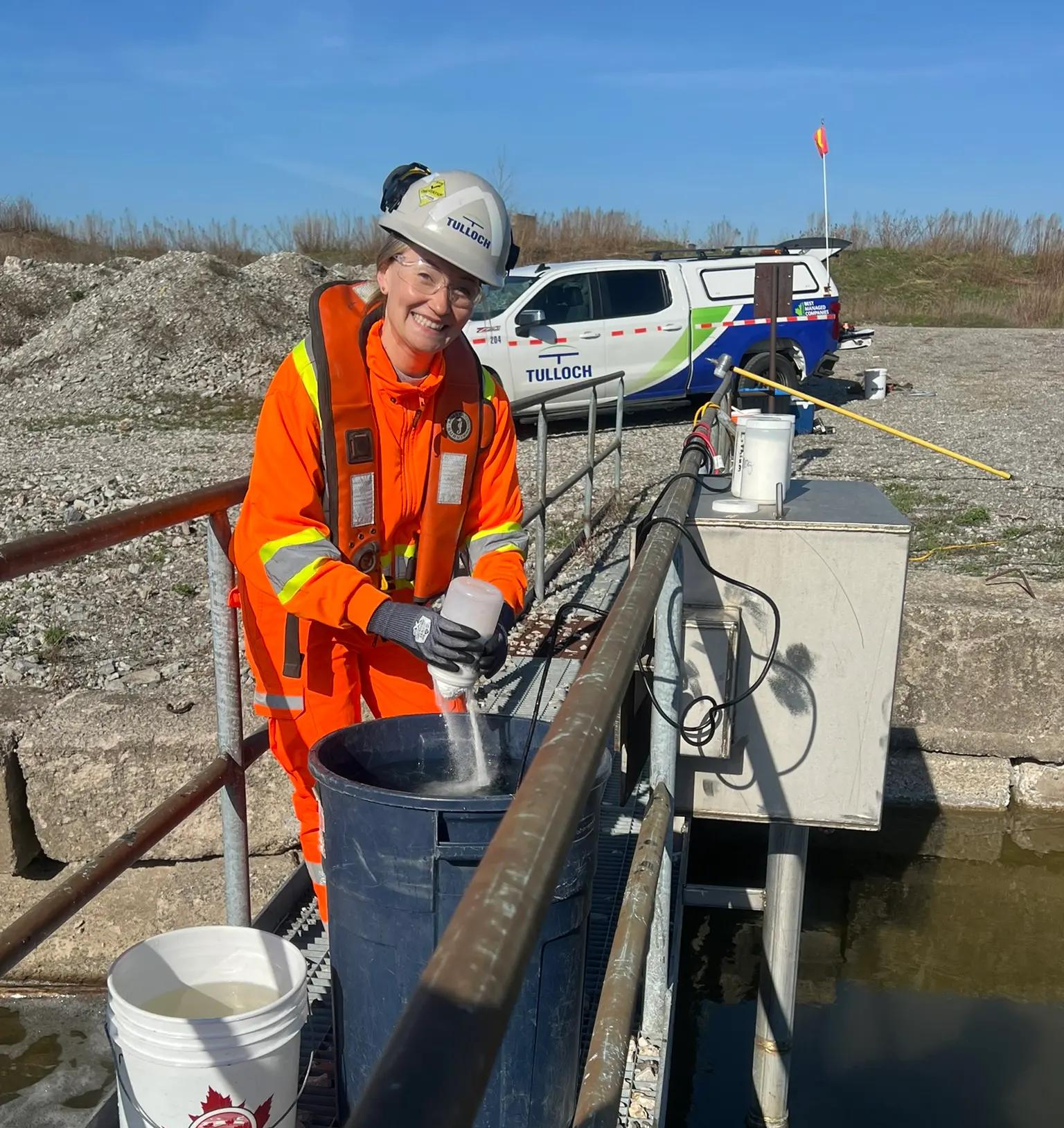 TULLOCH environmental field technician preparing equipment from a boat.