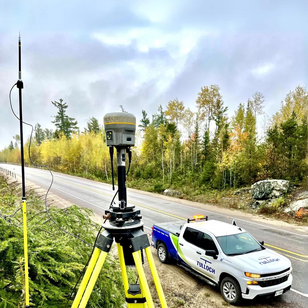 TULLOCH survey equipment and company truck set up beside a roadway.