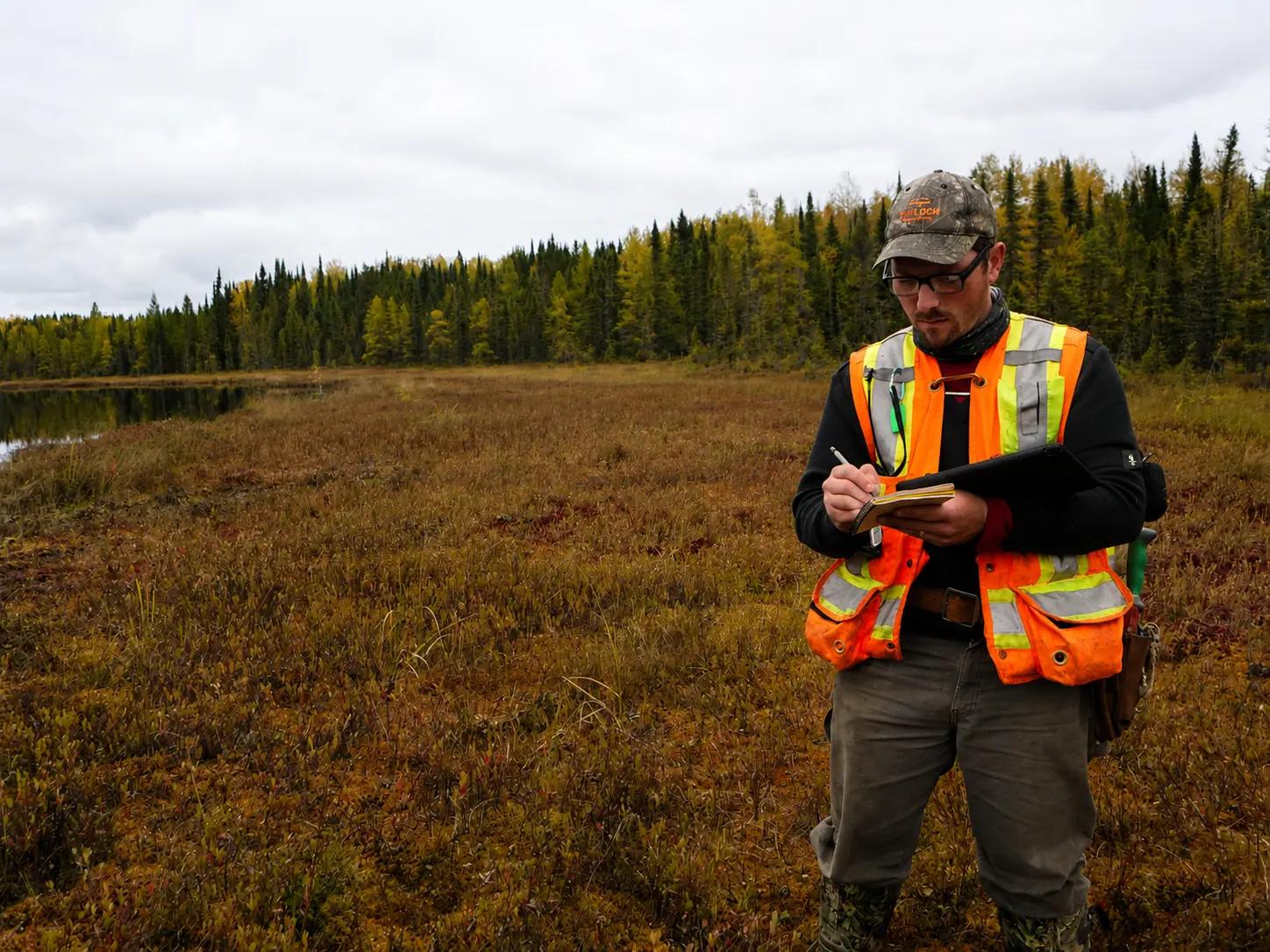 TULLOCH field technician using a tablet at a remote site.