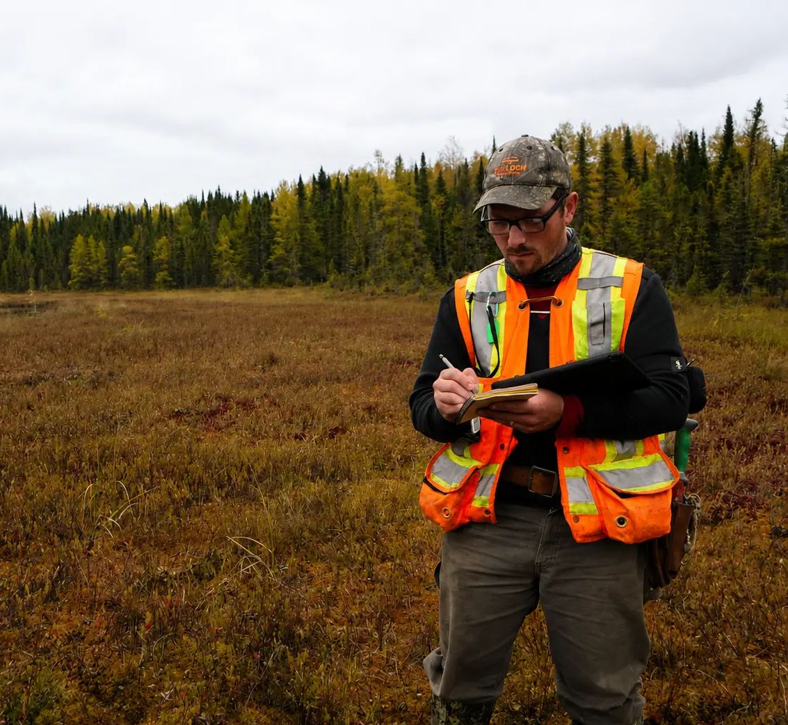 TULLOCH field technician using a tablet at a remote site.