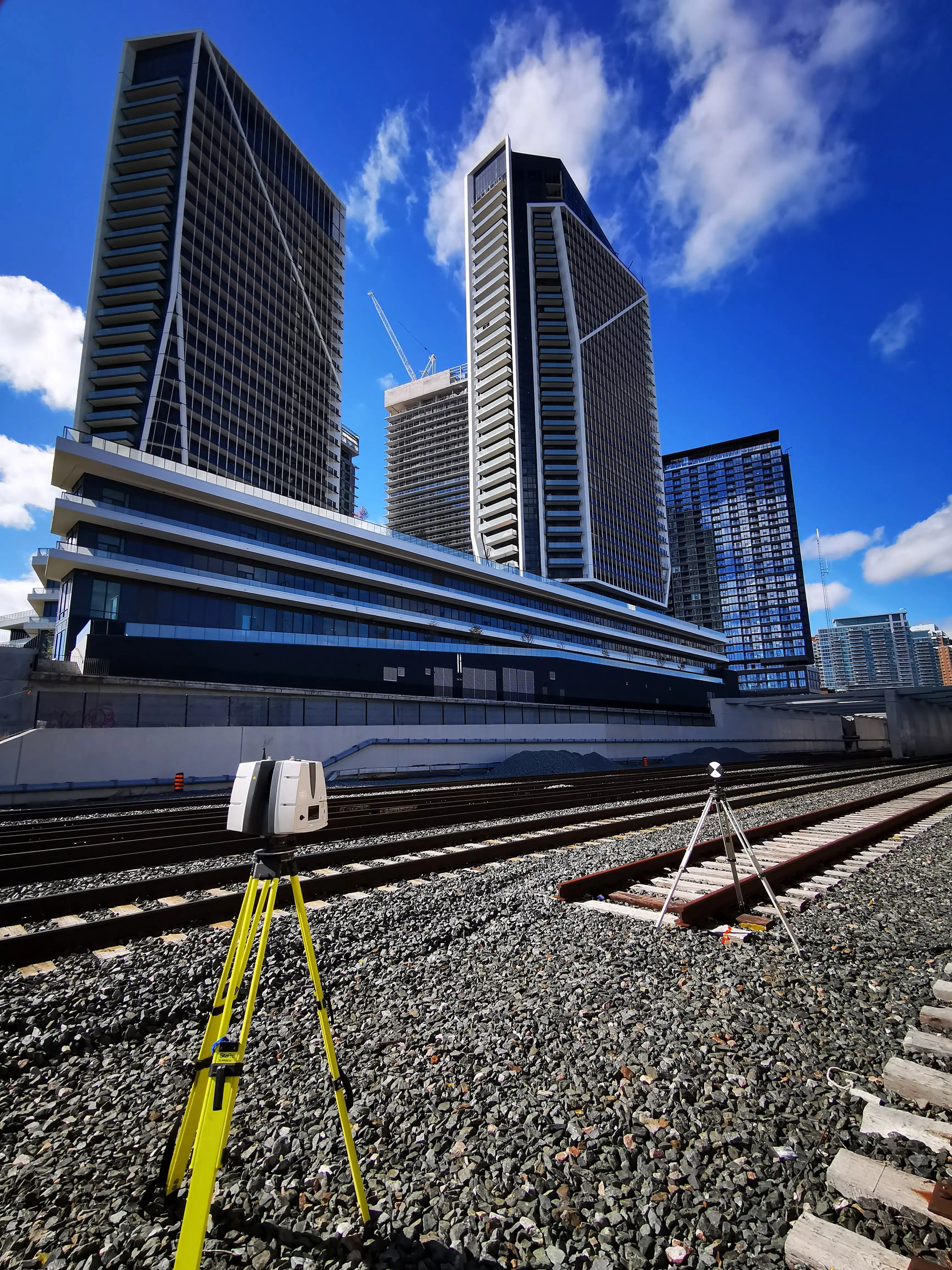 Survey equipment set up beside GO rail infrastructure for the GO Expansion program.