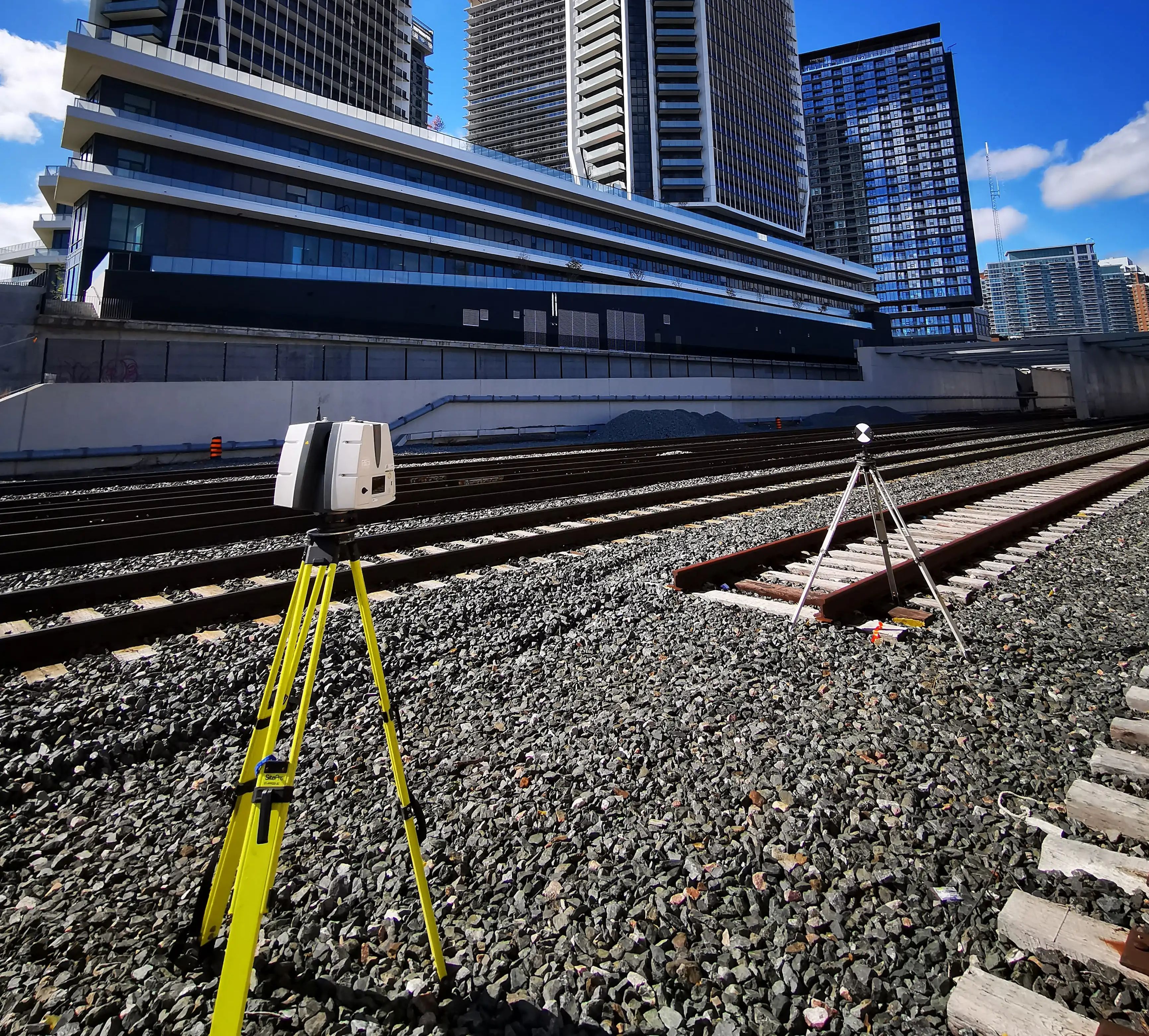 Survey equipment set up beside GO rail infrastructure for the GO Expansion program.
