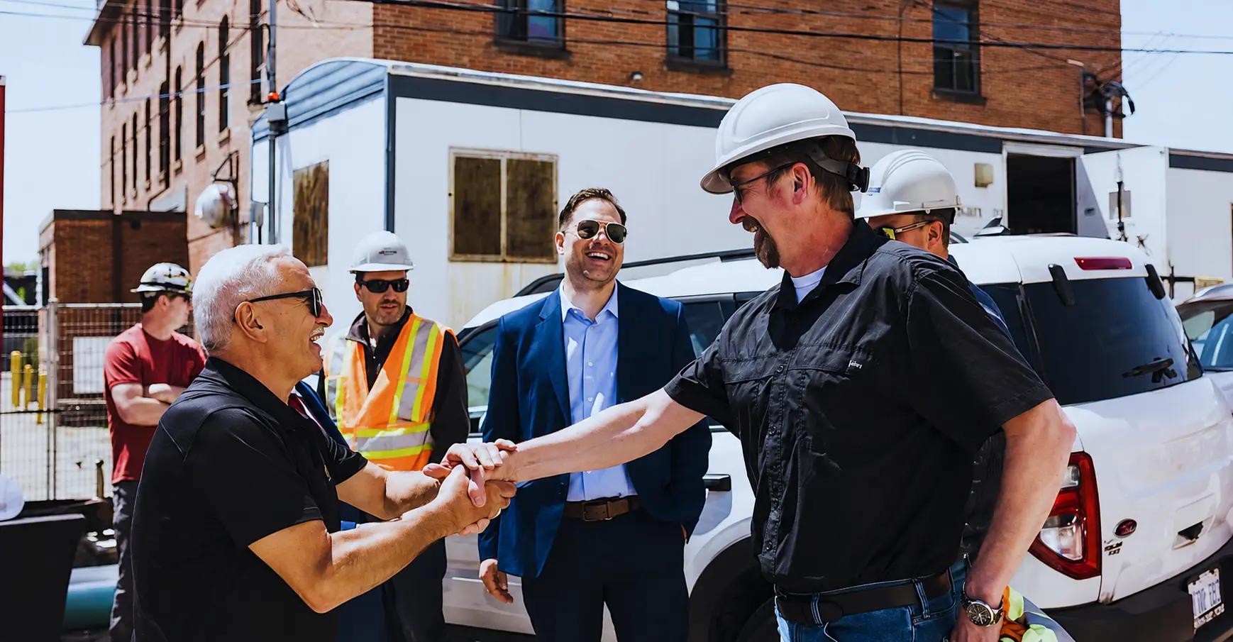 Shaking hands with TULLOCH project manager at new building.