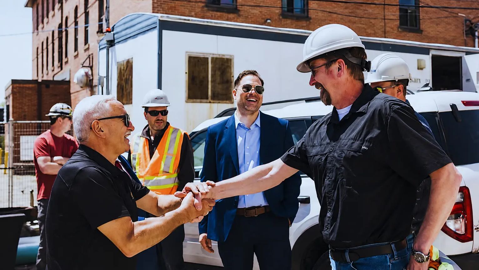 Shaking hands with TULLOCH project manager at new building.