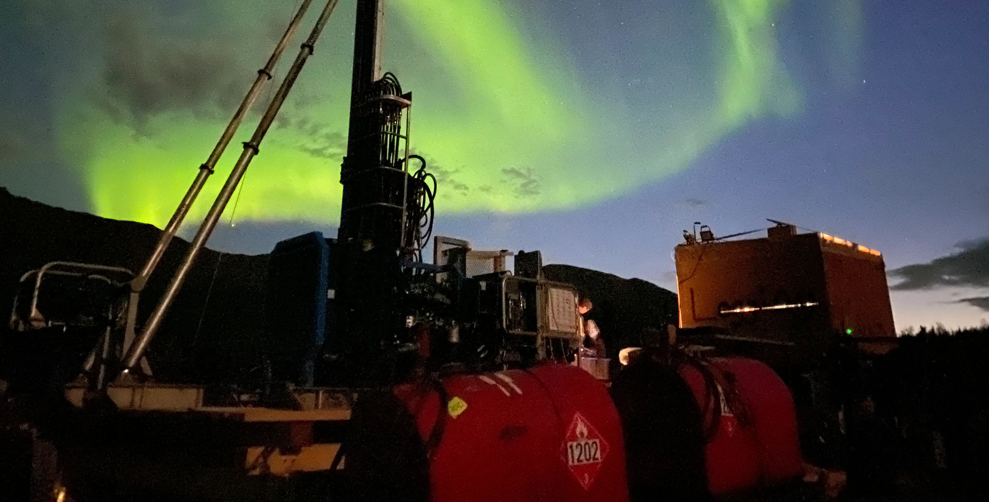 Drilling equipment operating under northern lights at the remote Goose Gold Mine in Nunavut.