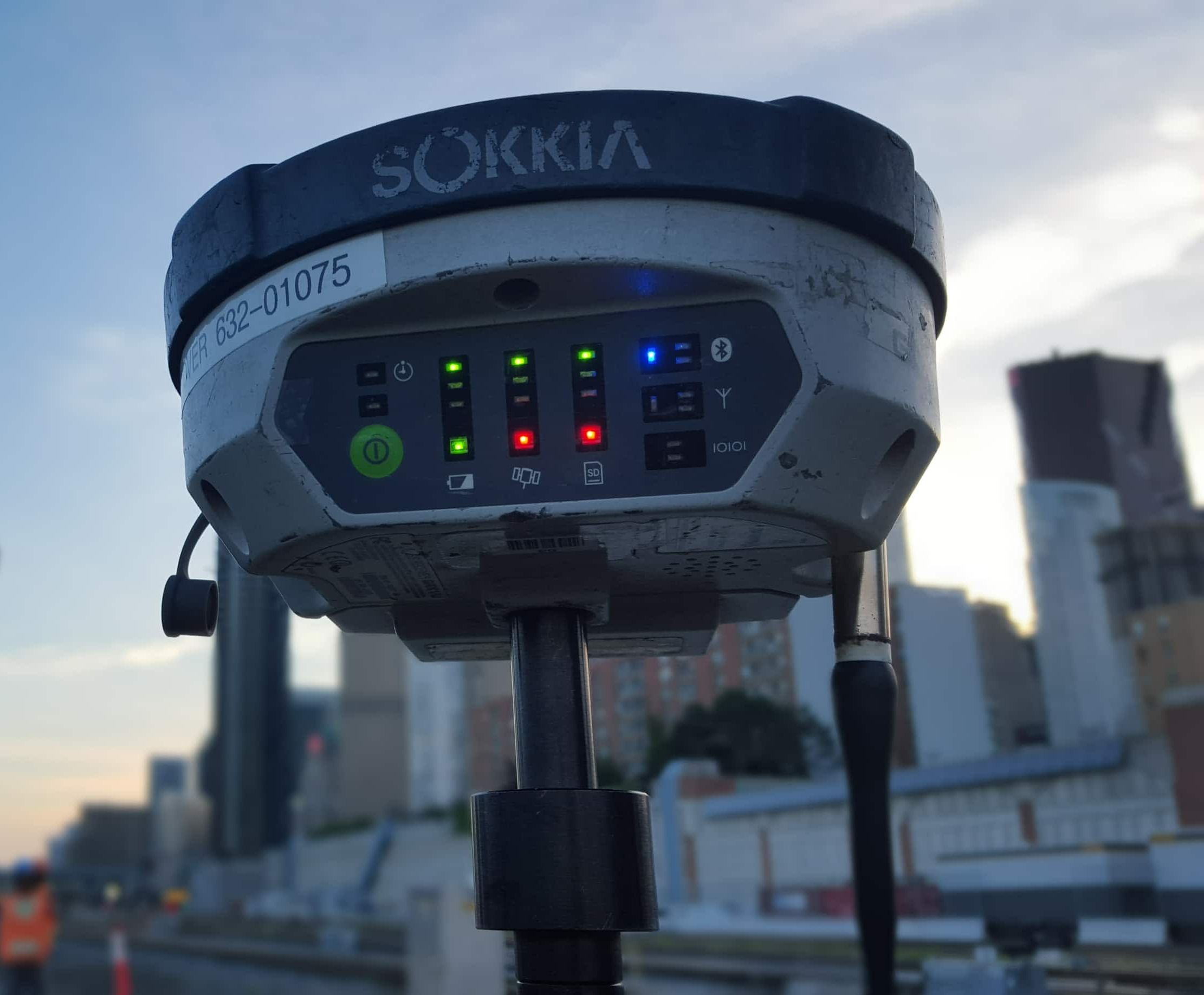 GNSS survey receiver used for rail corridor surveying with the Toronto skyline in the background.