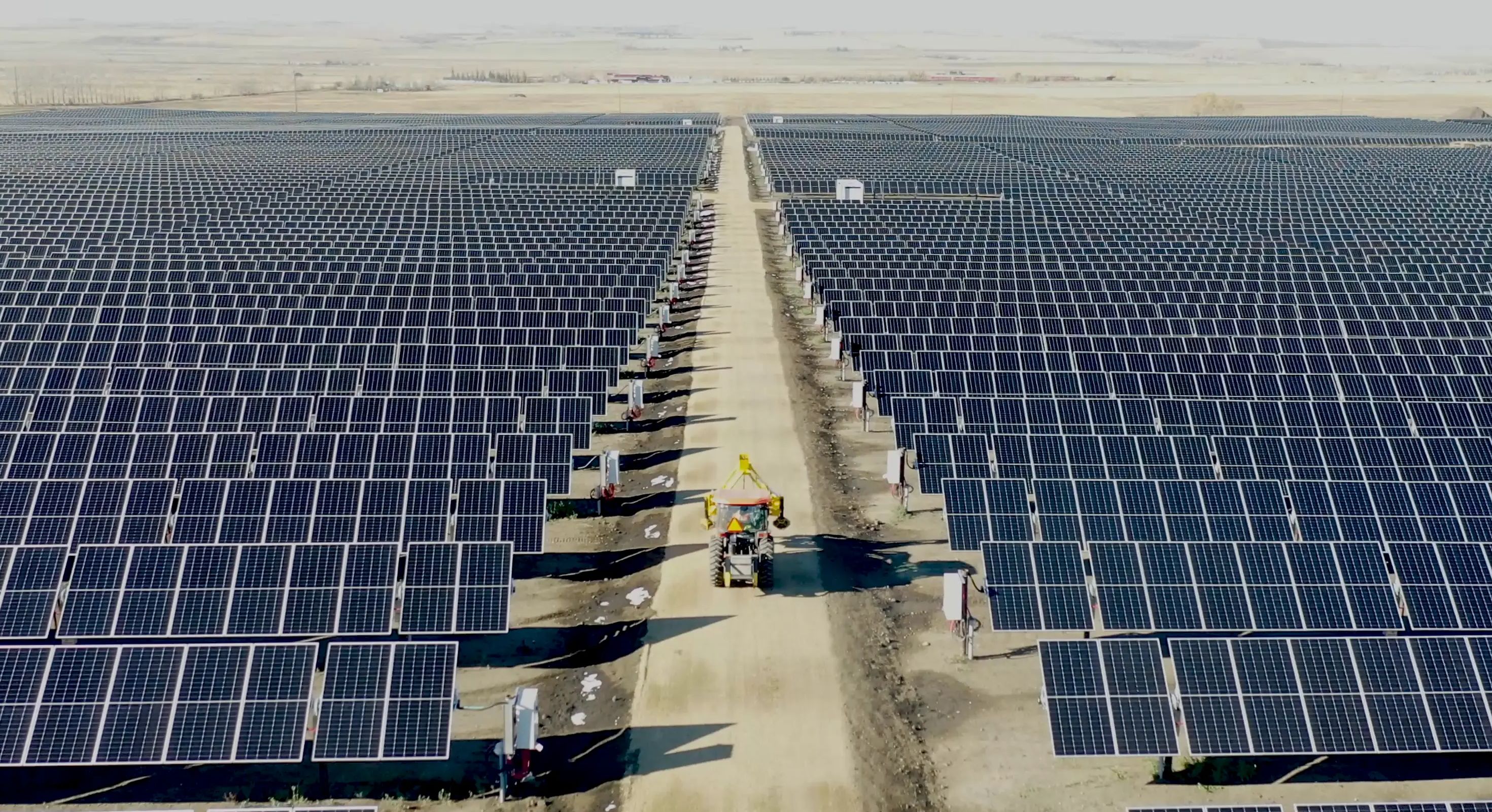 Large utility-scale solar array extending across an open site.