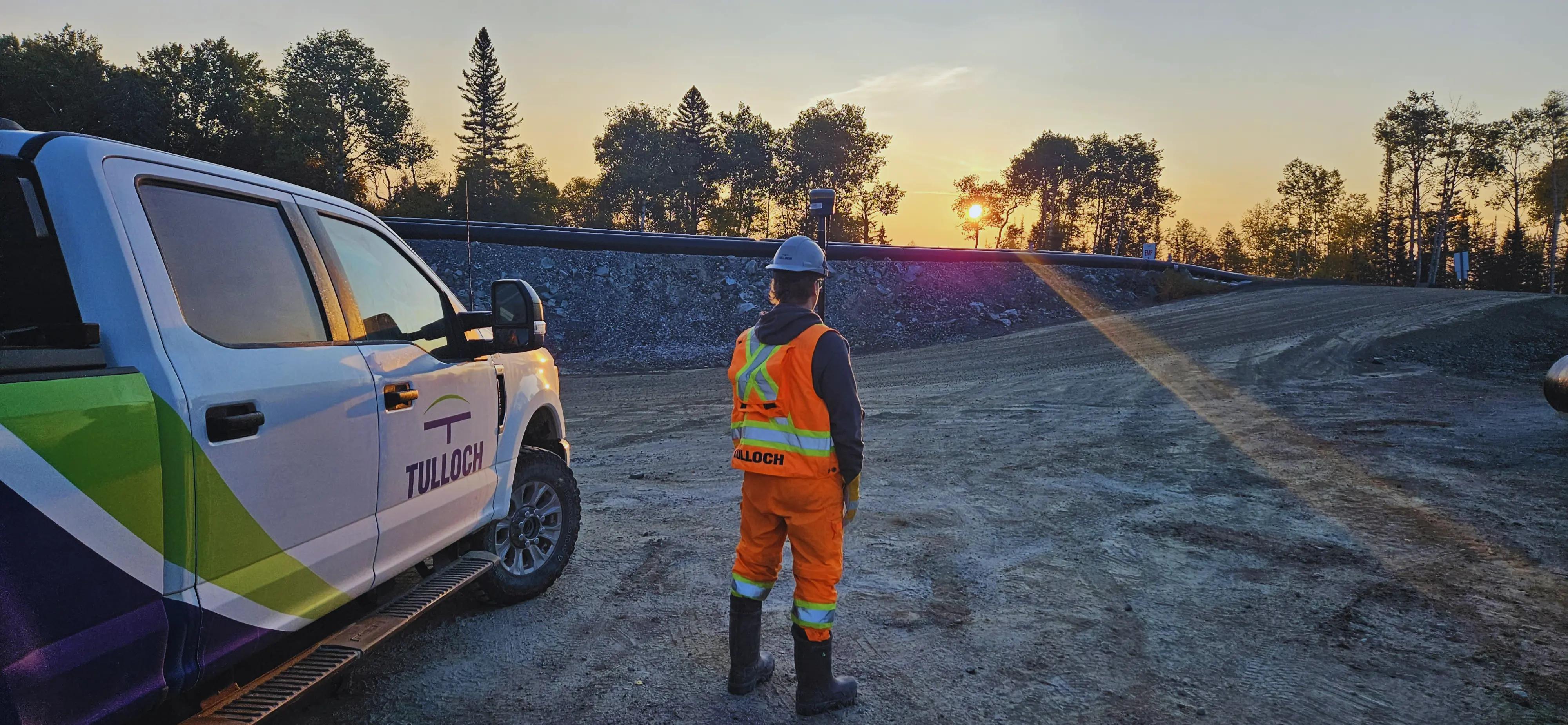 TULLOCH surveyor working beside a company truck at the Cote Gold mine.