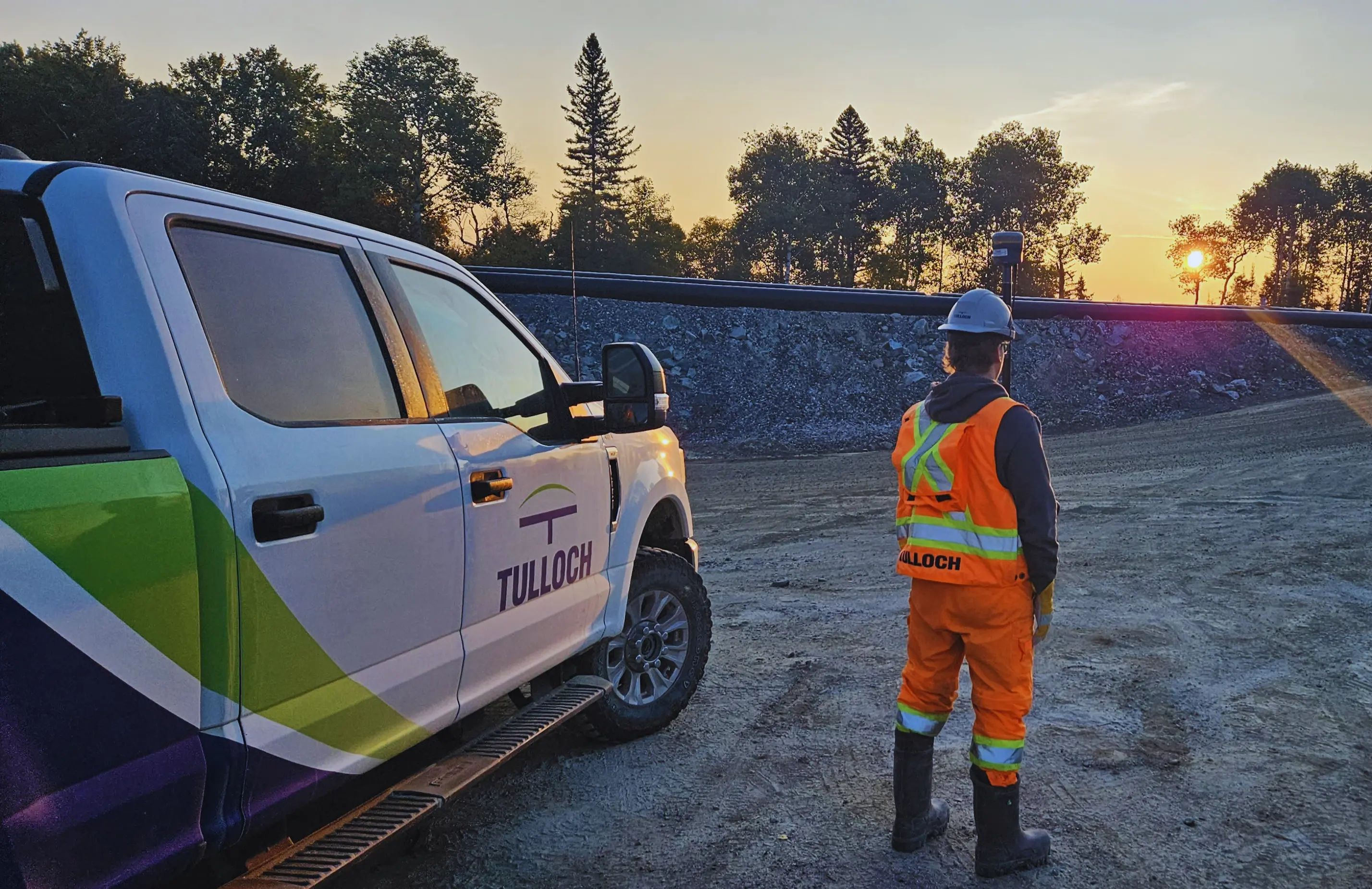 TULLOCH surveyor working beside a company truck at the Cote Gold mine.