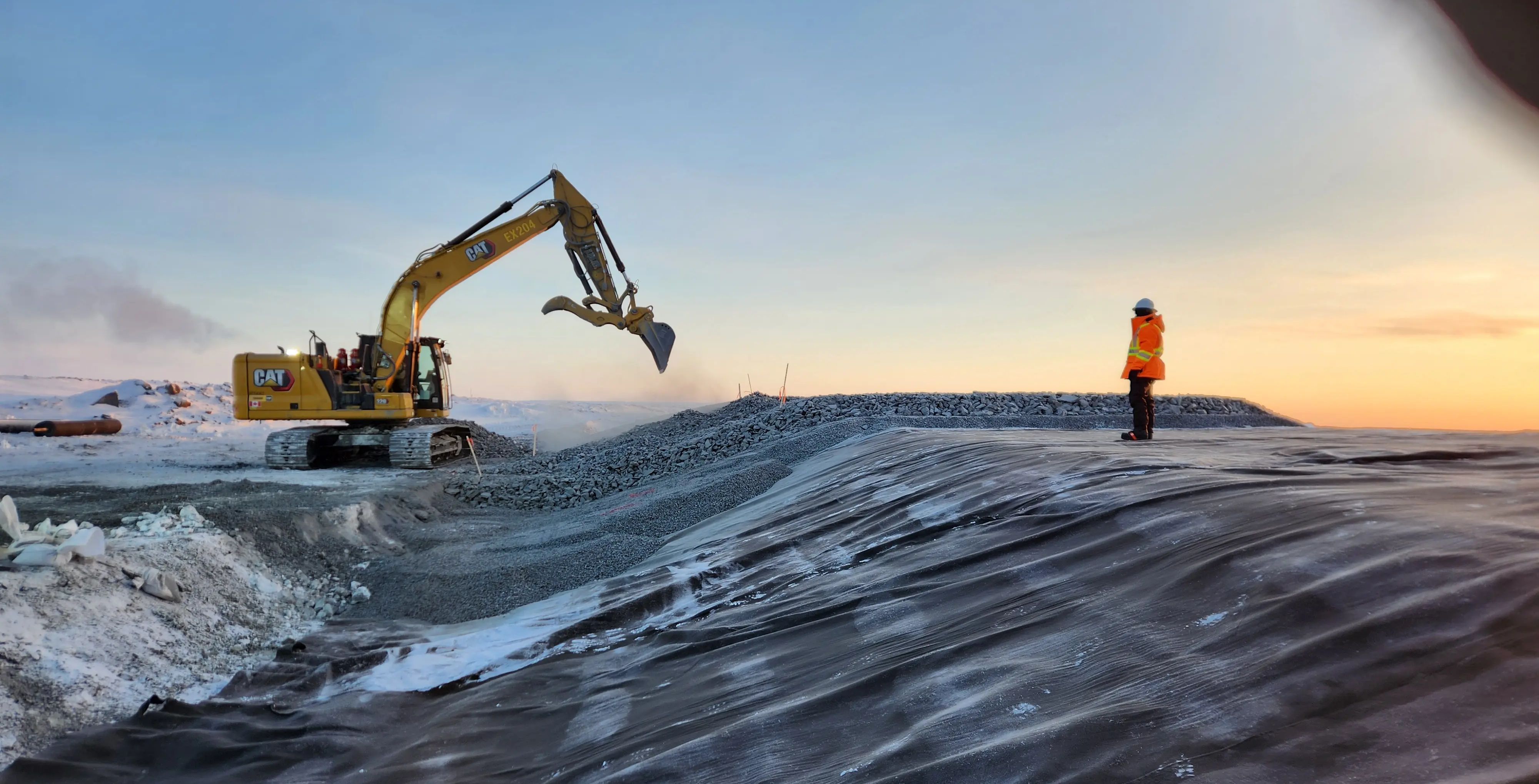 Earthworks and quality assurance activities during dam construction at Goose Gold Mine in Nunavut.