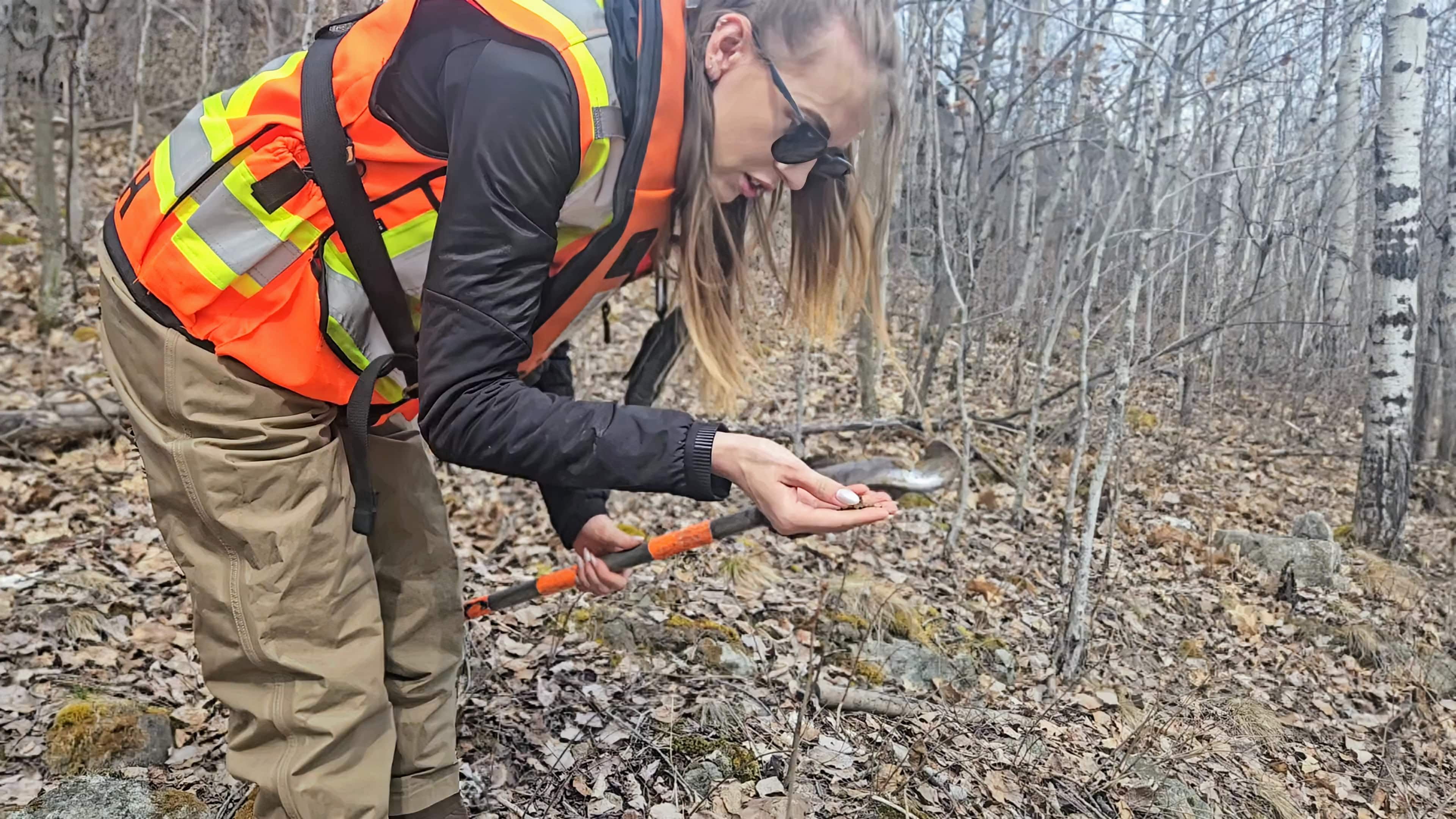 TULLOCH environmental field technician examining soil during a site assessment.