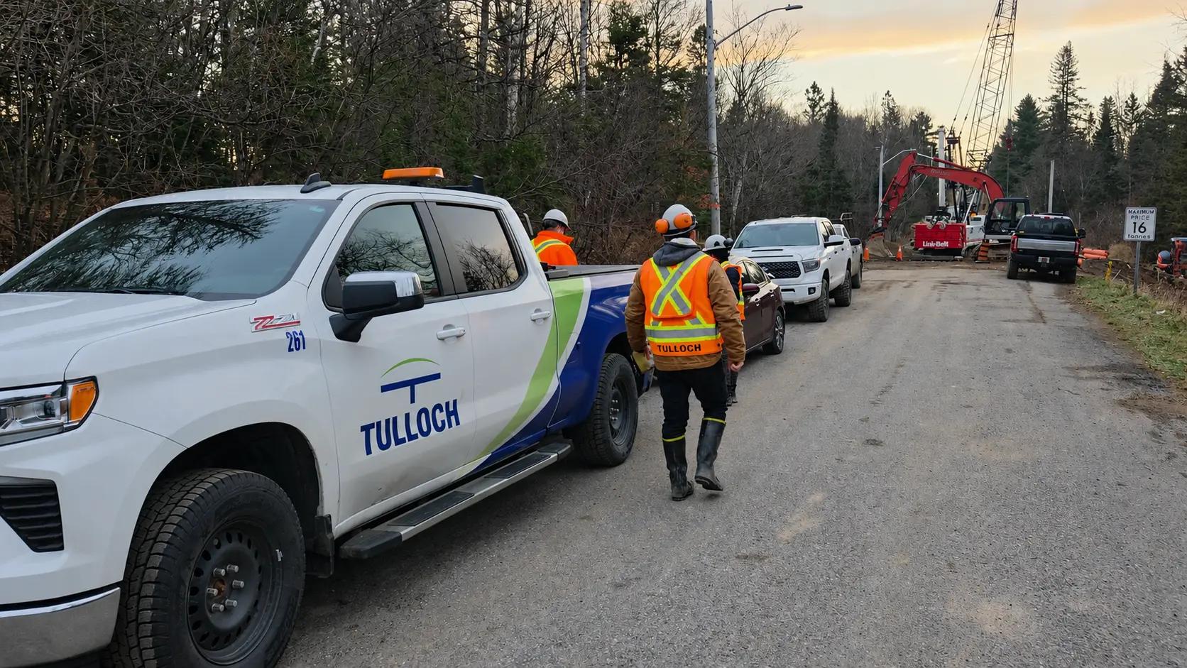 TULLOCH field staff and company vehicles at an active municipal construction project.