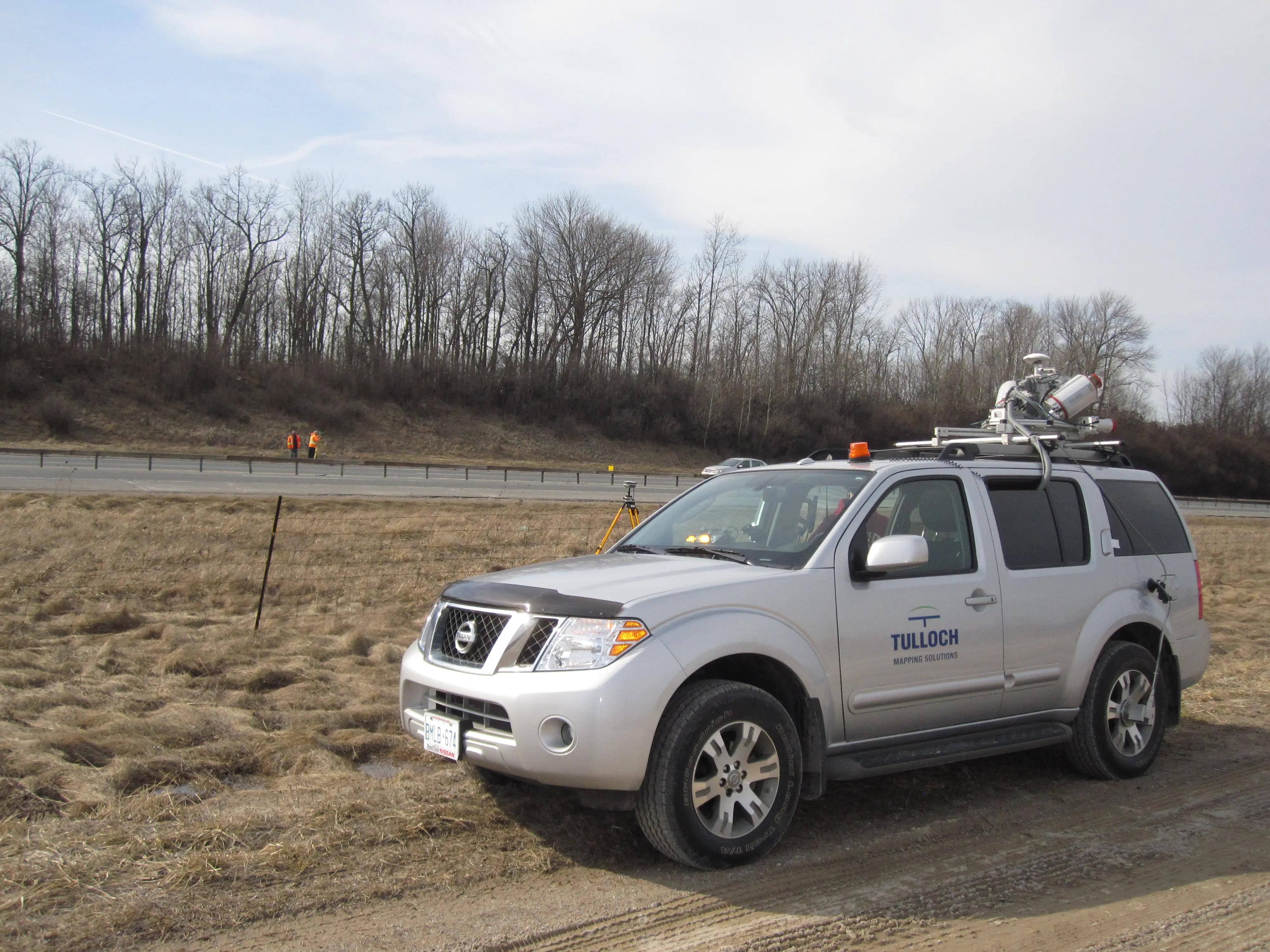 TULLOCH mobile LiDAR vehicle positioned beside Highway 400 for corridor data collection.