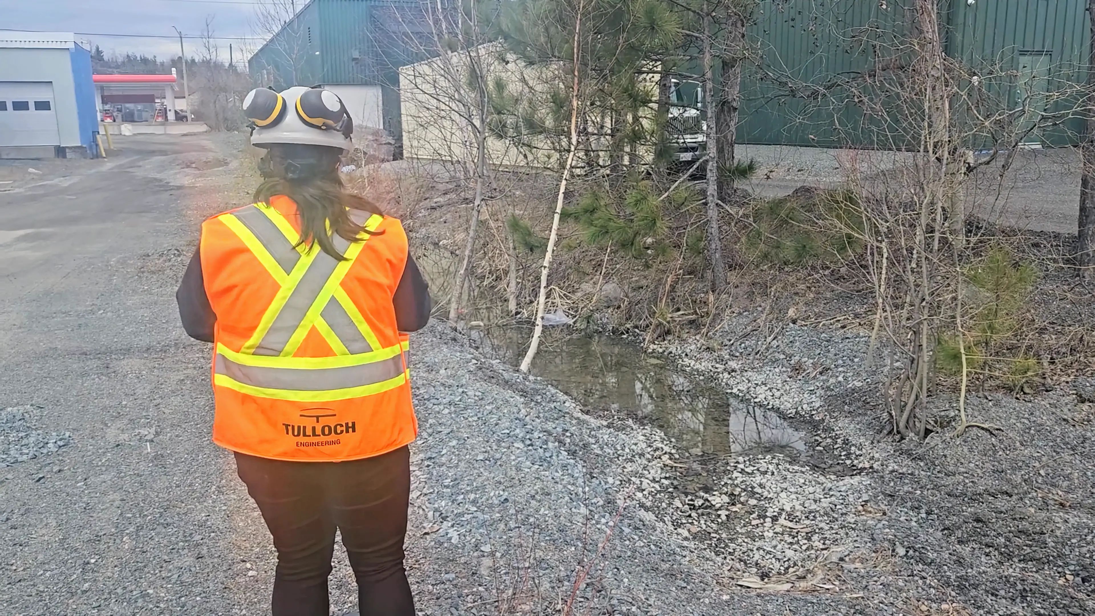 TULLOCH field technician reviewing drainage conditions near Pim Street.