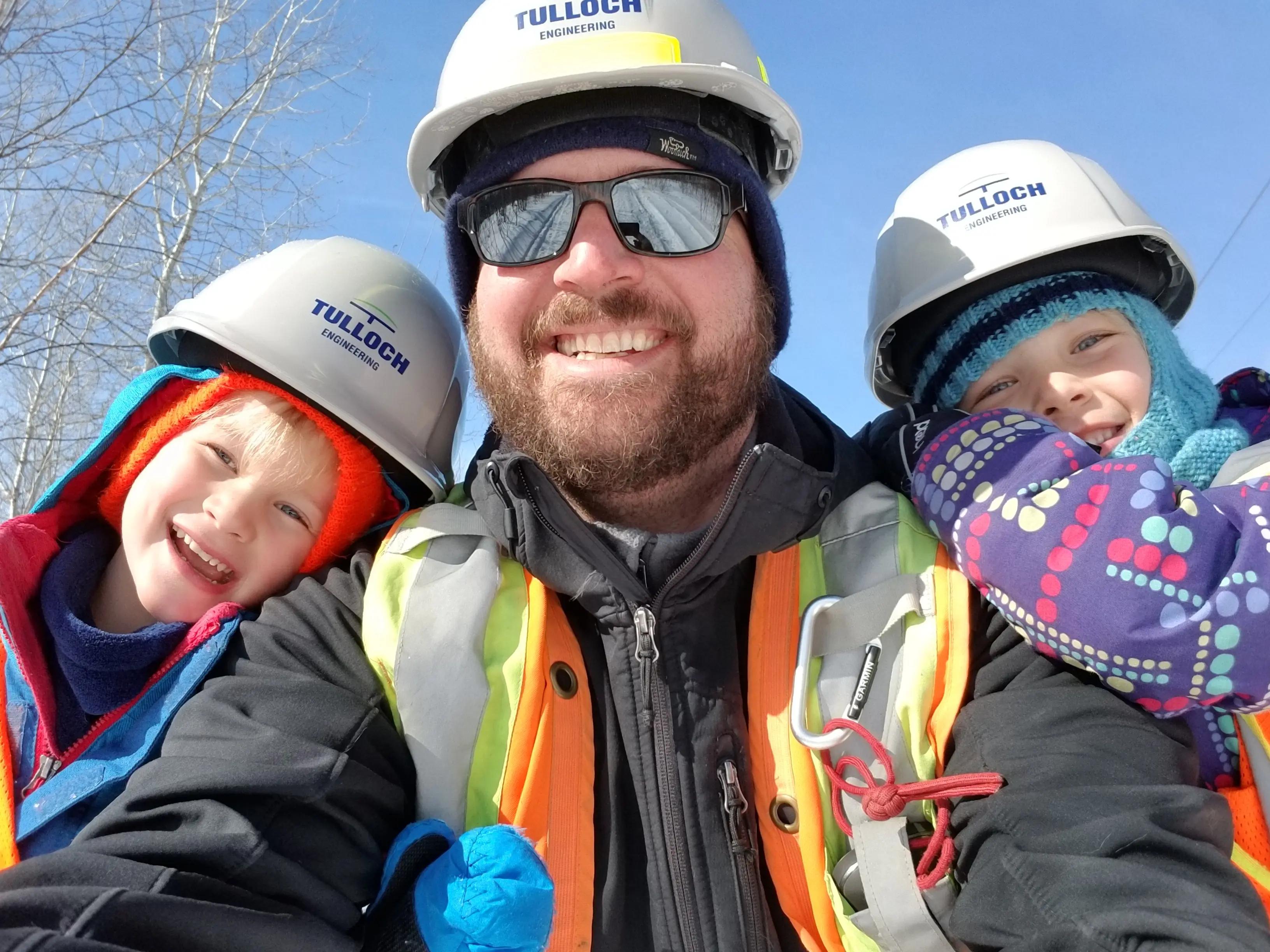 Staff member and kids enjoying a winter day.