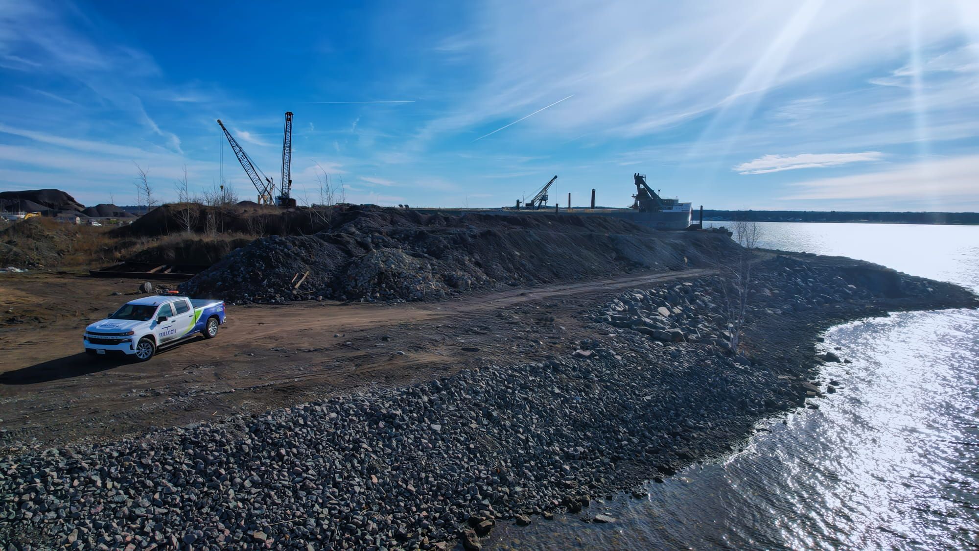 Industrial embankment beside a waterbody.