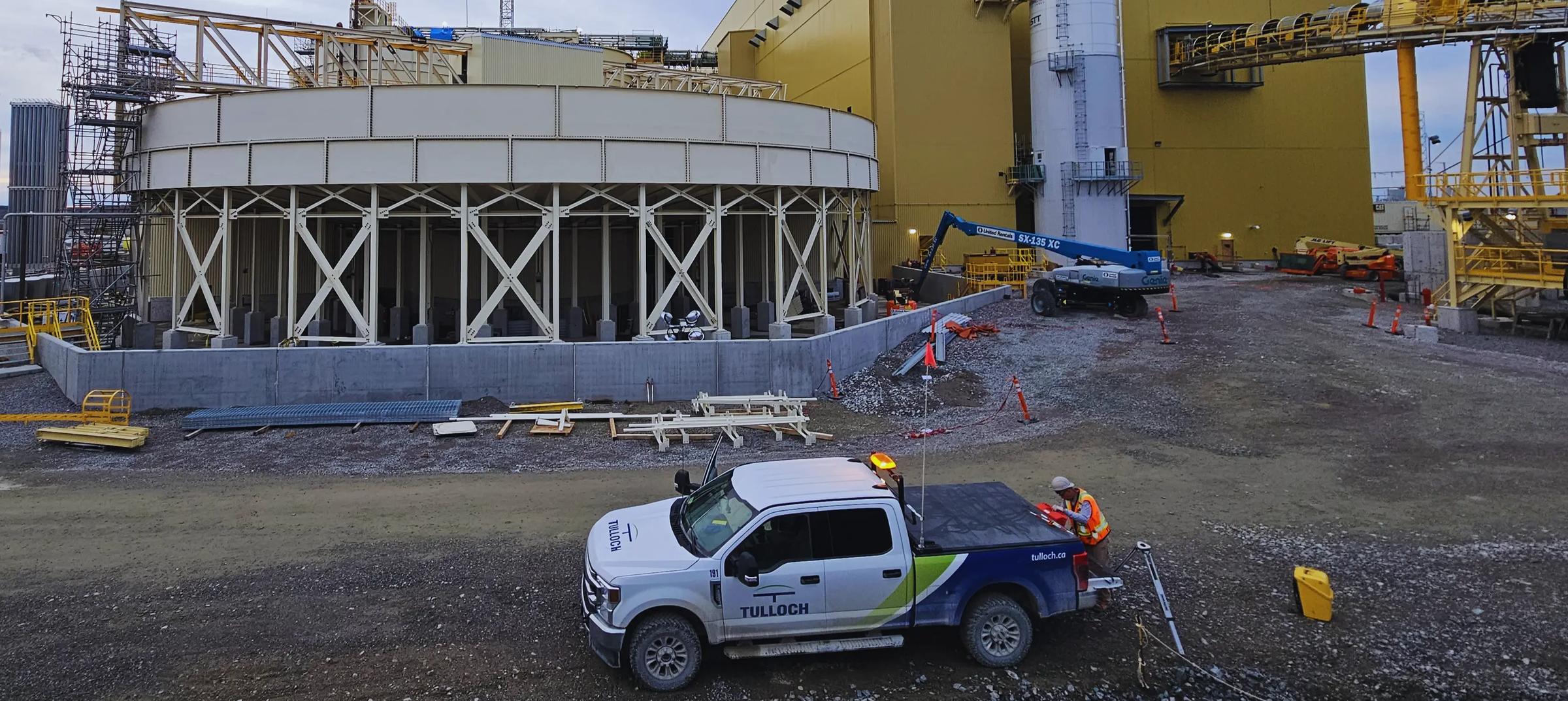 Active mine building construction site with a TULLOCH field vehicle.