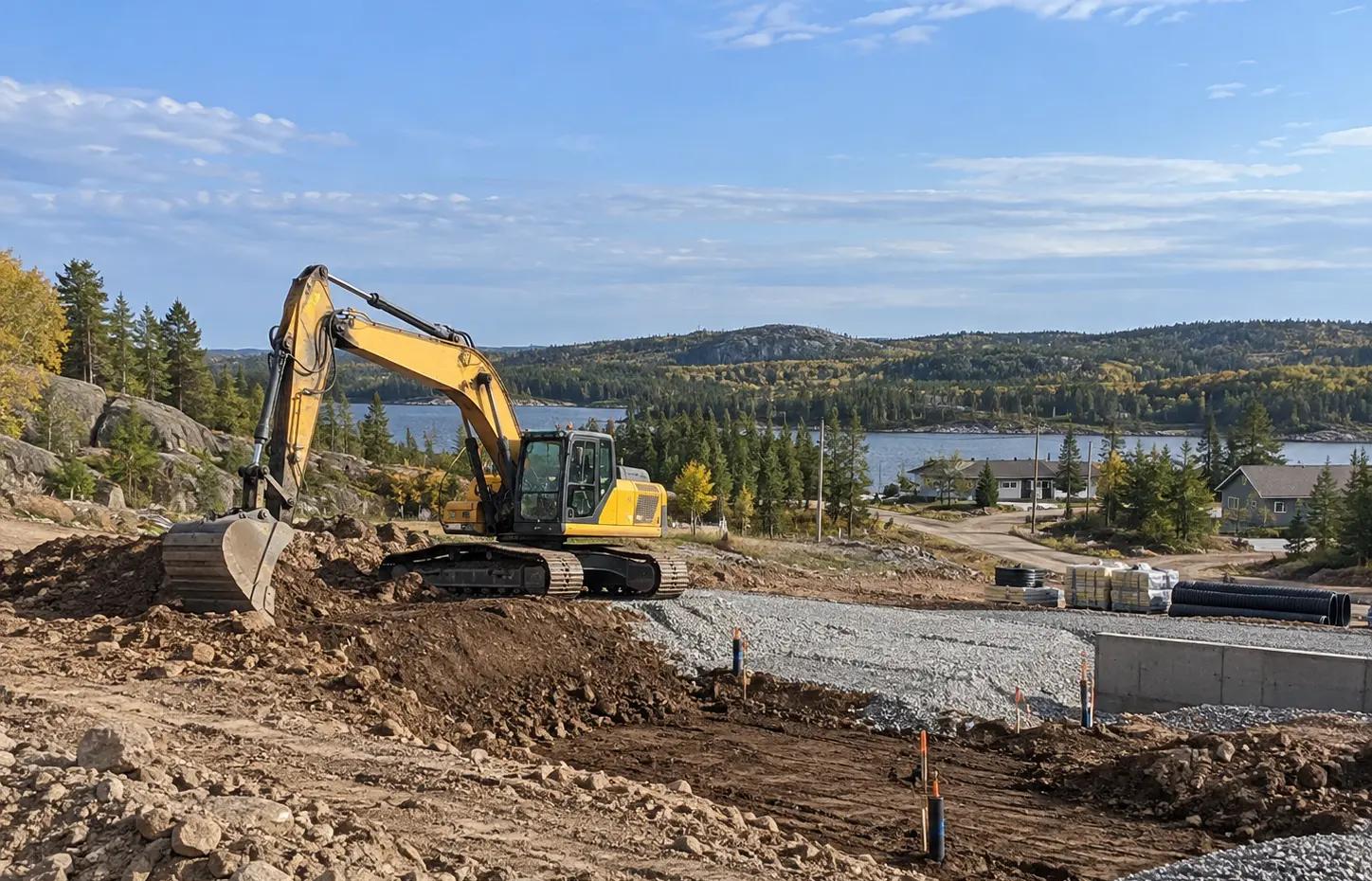 Excavator completing remedial earthworks at Serpent River First Nation.