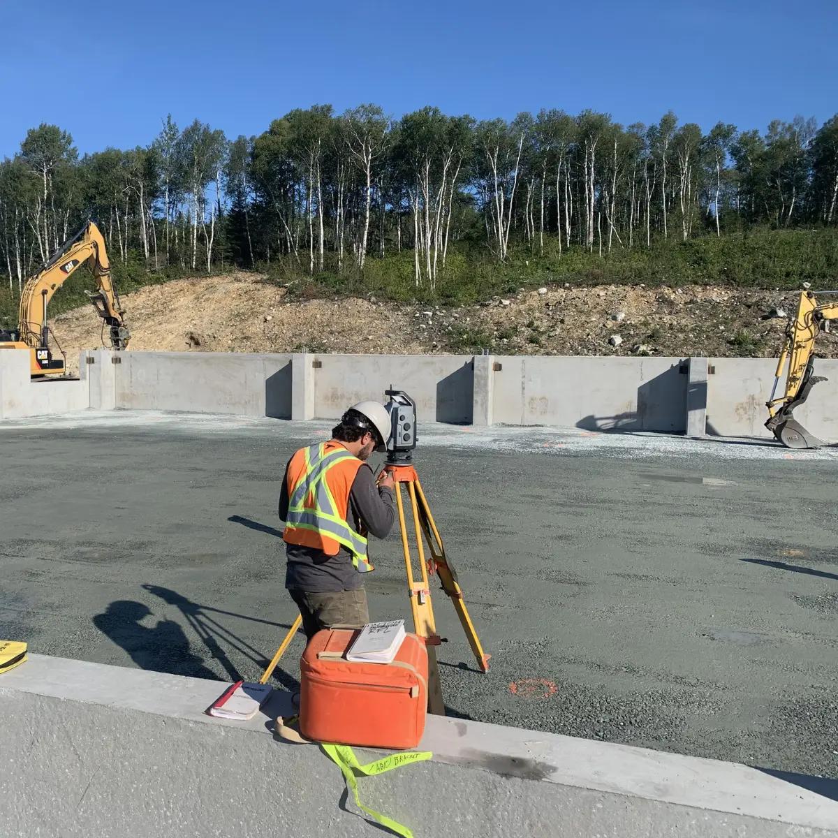 TULLOCH survey technician collecting field data at an active construction site.