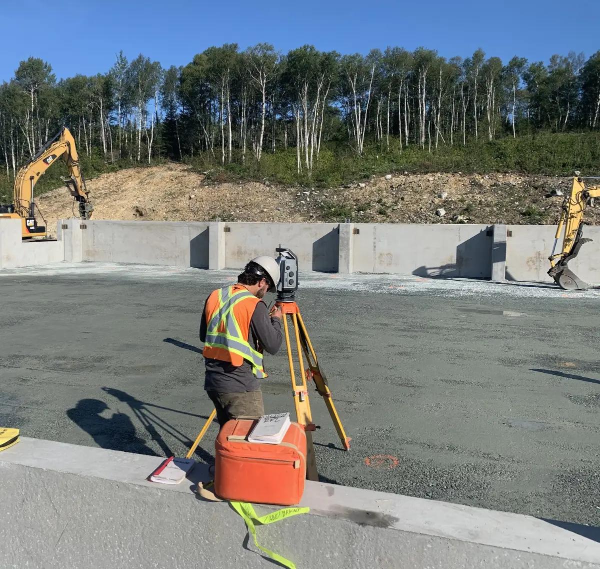 TULLOCH survey technician collecting field data at an active construction site.