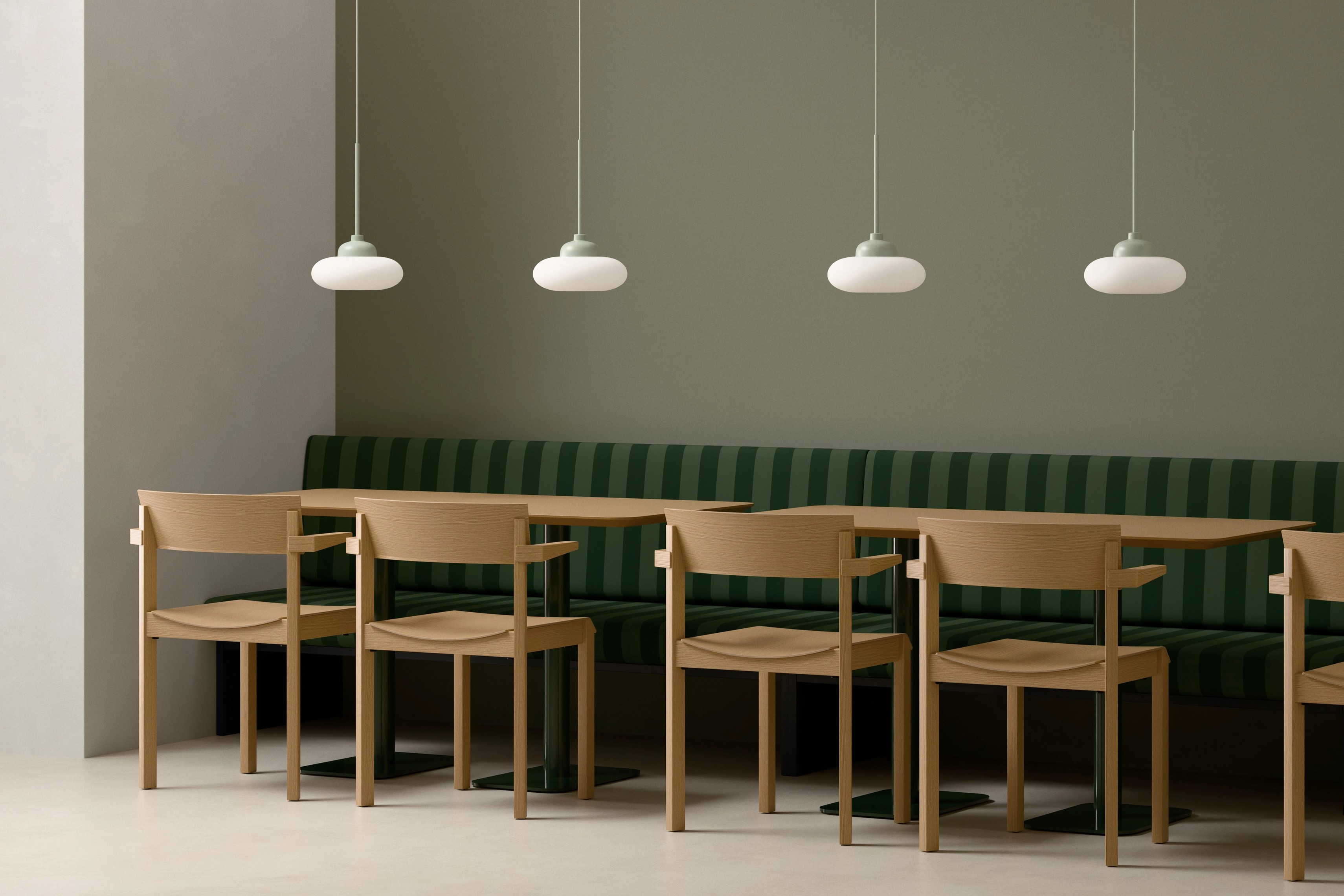 Split Round Orbit Pendant Lamps above a bench seat in a hospitality setting