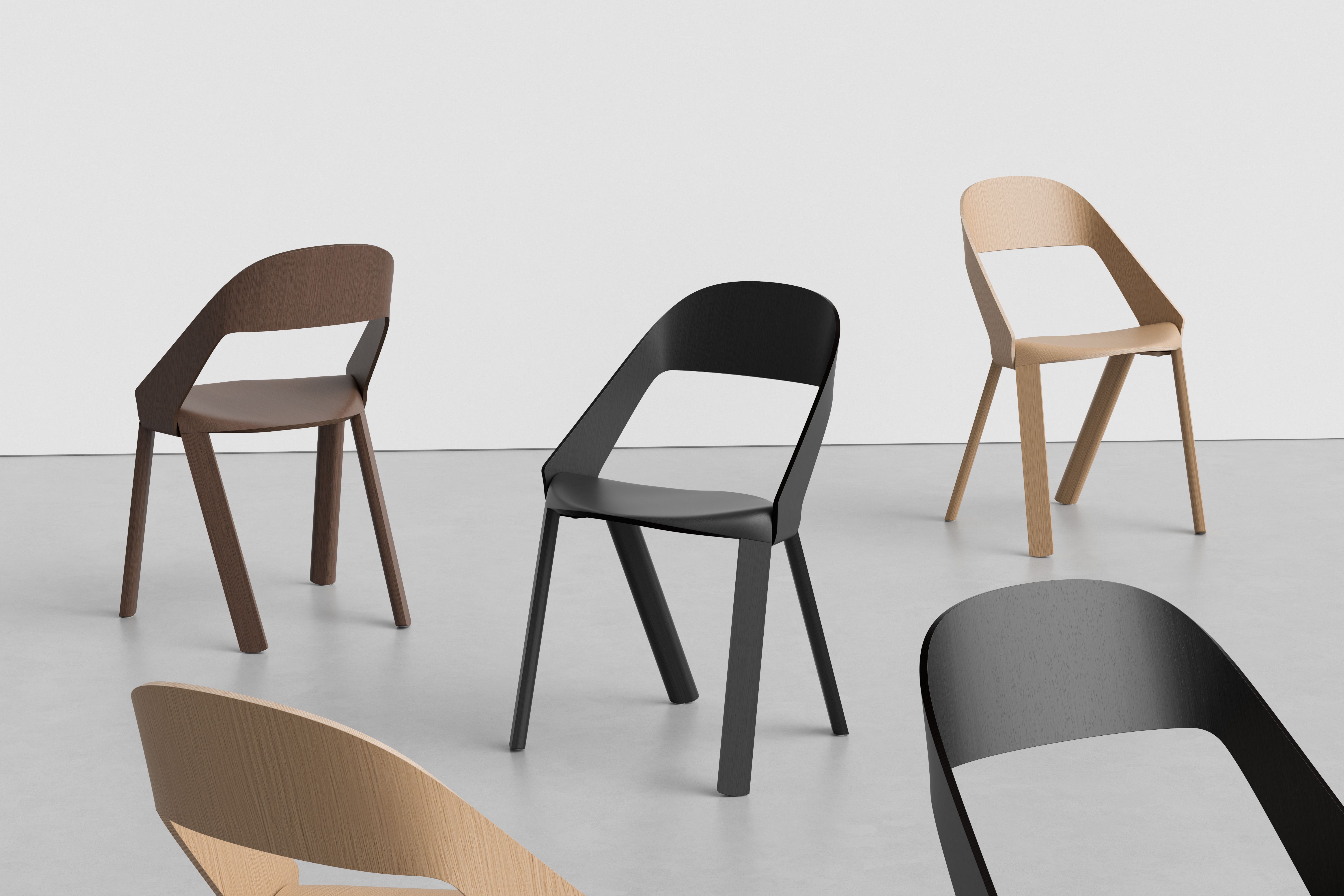 Rove Wooden Chair in brown, black, and natural oak, arranged across a light studio space