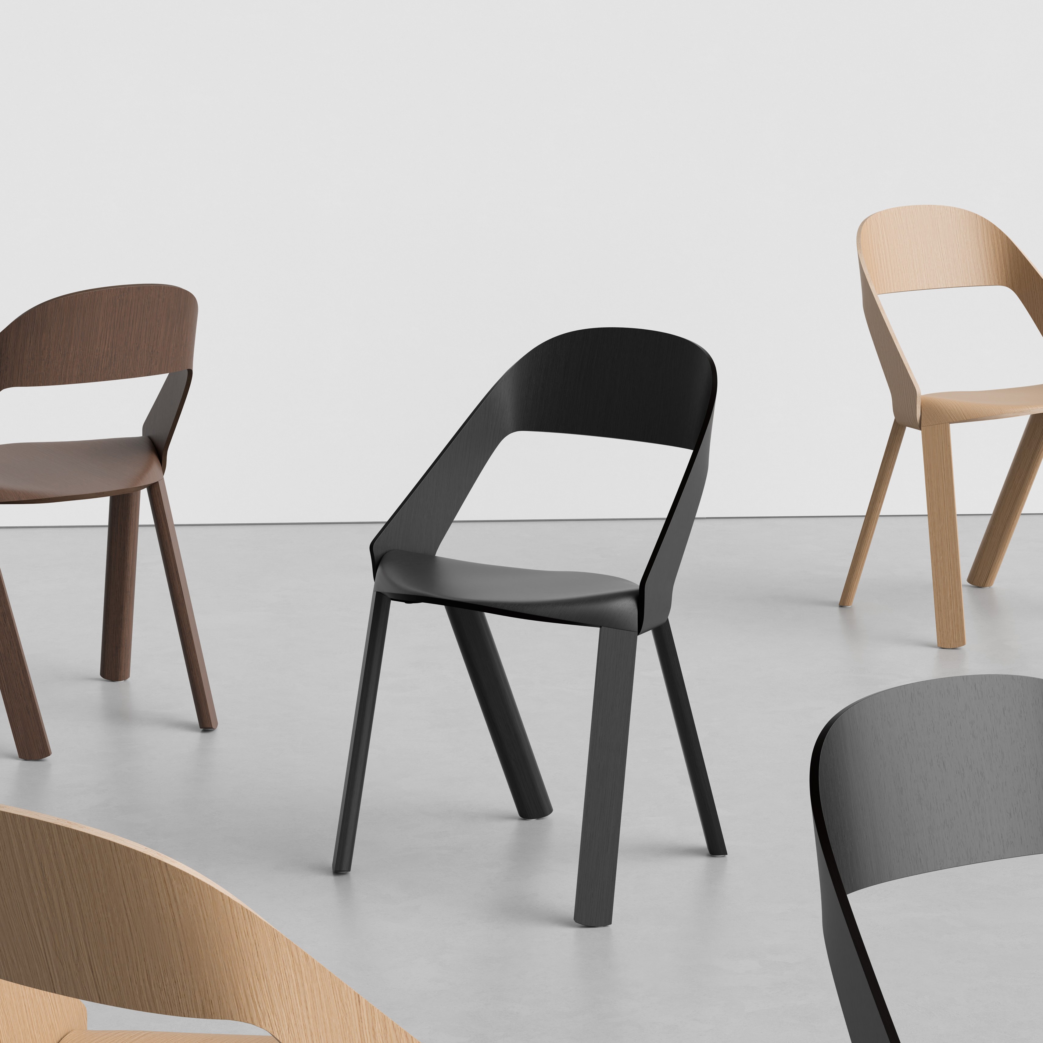 Rove Wooden Chair in brown, black, and natural oak, arranged across a light studio space