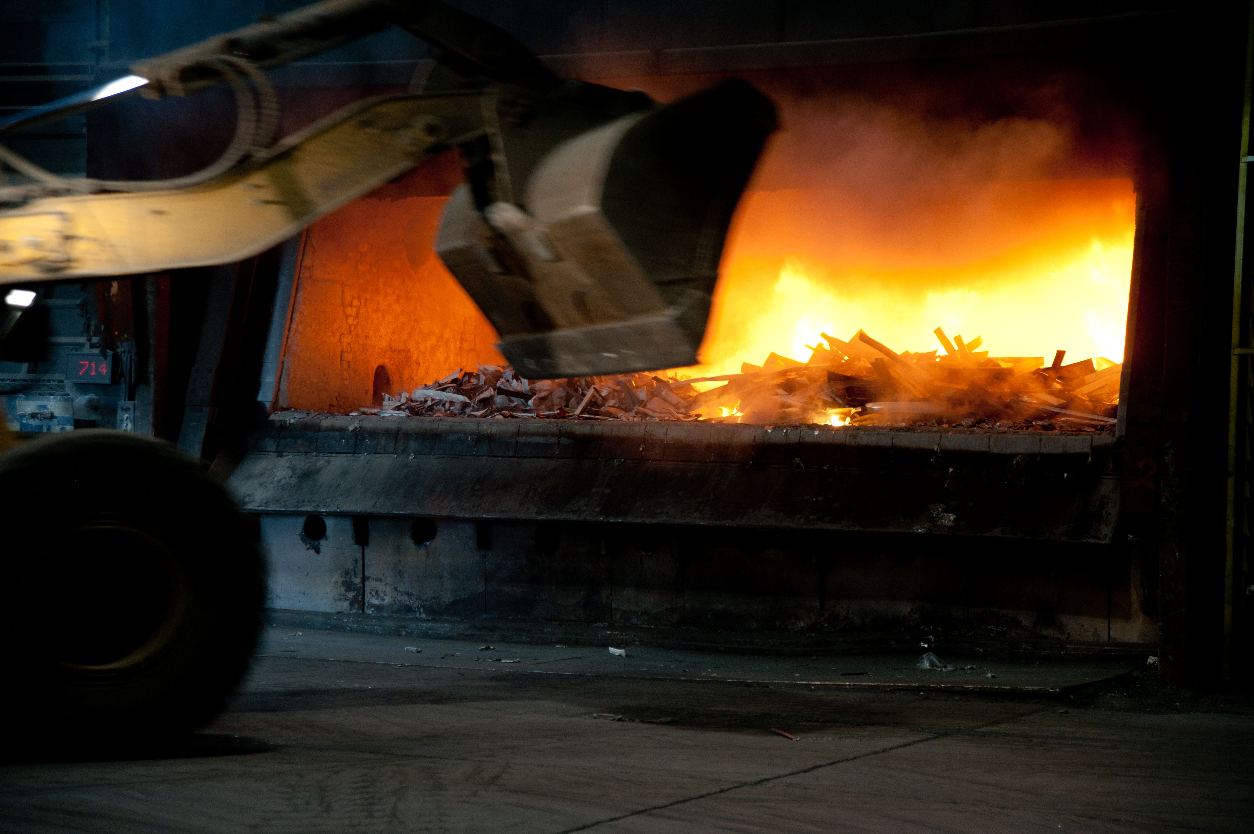 Recycled aluminium scrap being loaded into a melting furnace during the circular aluminium production process