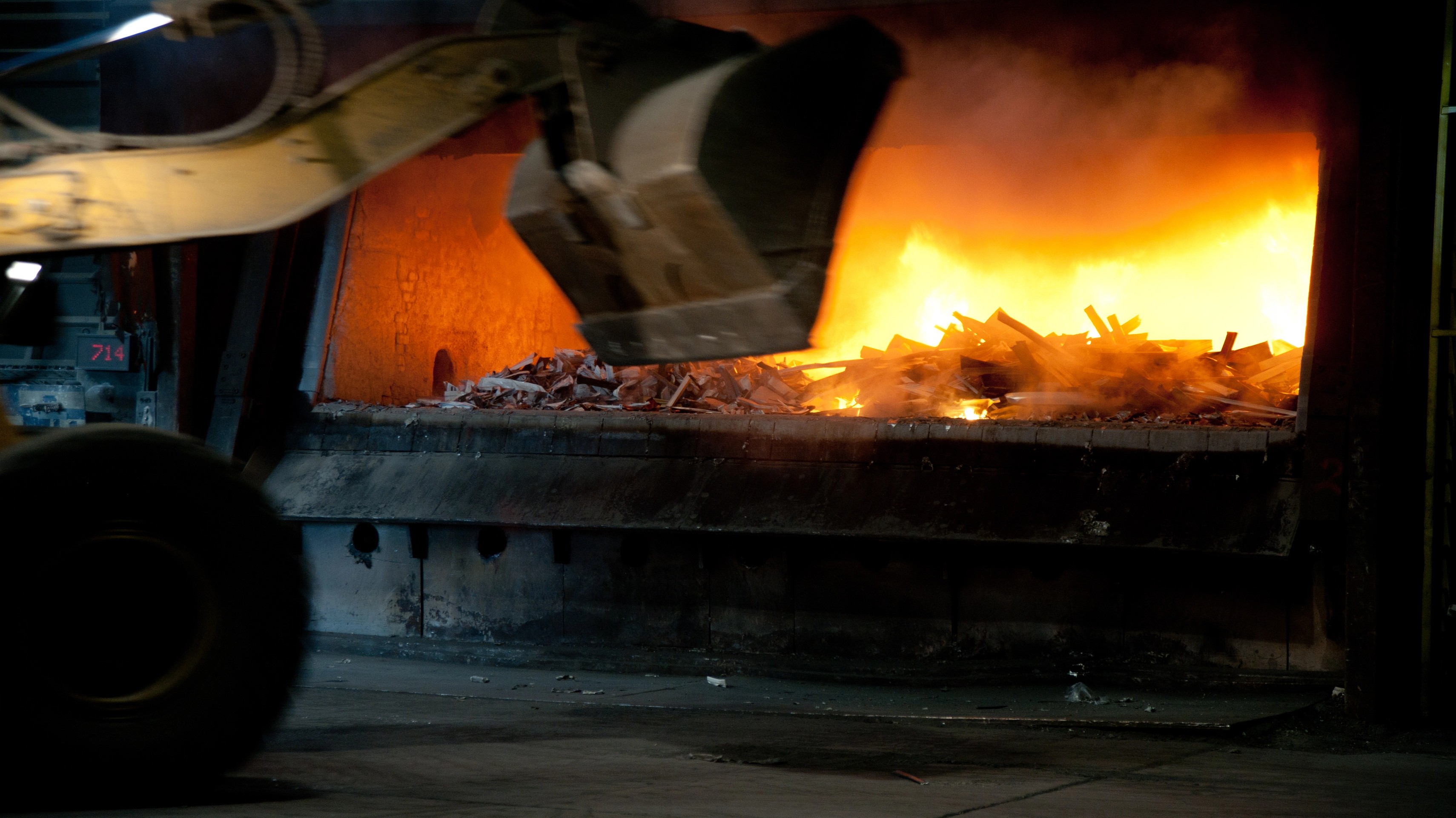 Recycled aluminium scrap being loaded into a melting furnace during the circular aluminium production process