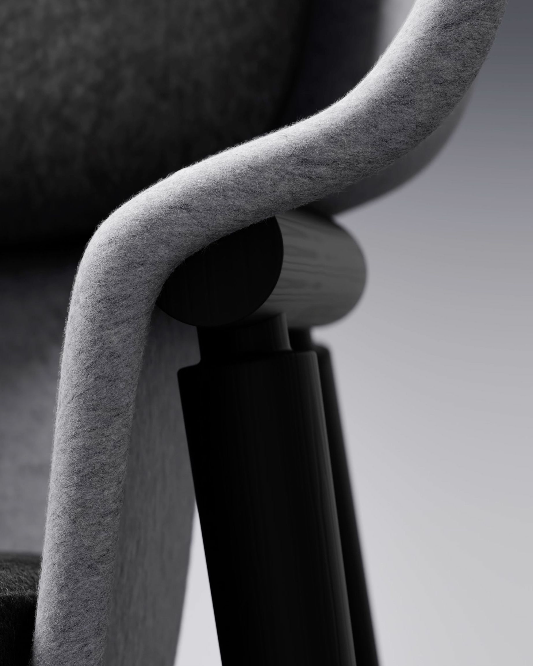 Pod PET Felt Privacy Chair, close-up detail of PET felt armrest and black frame connection