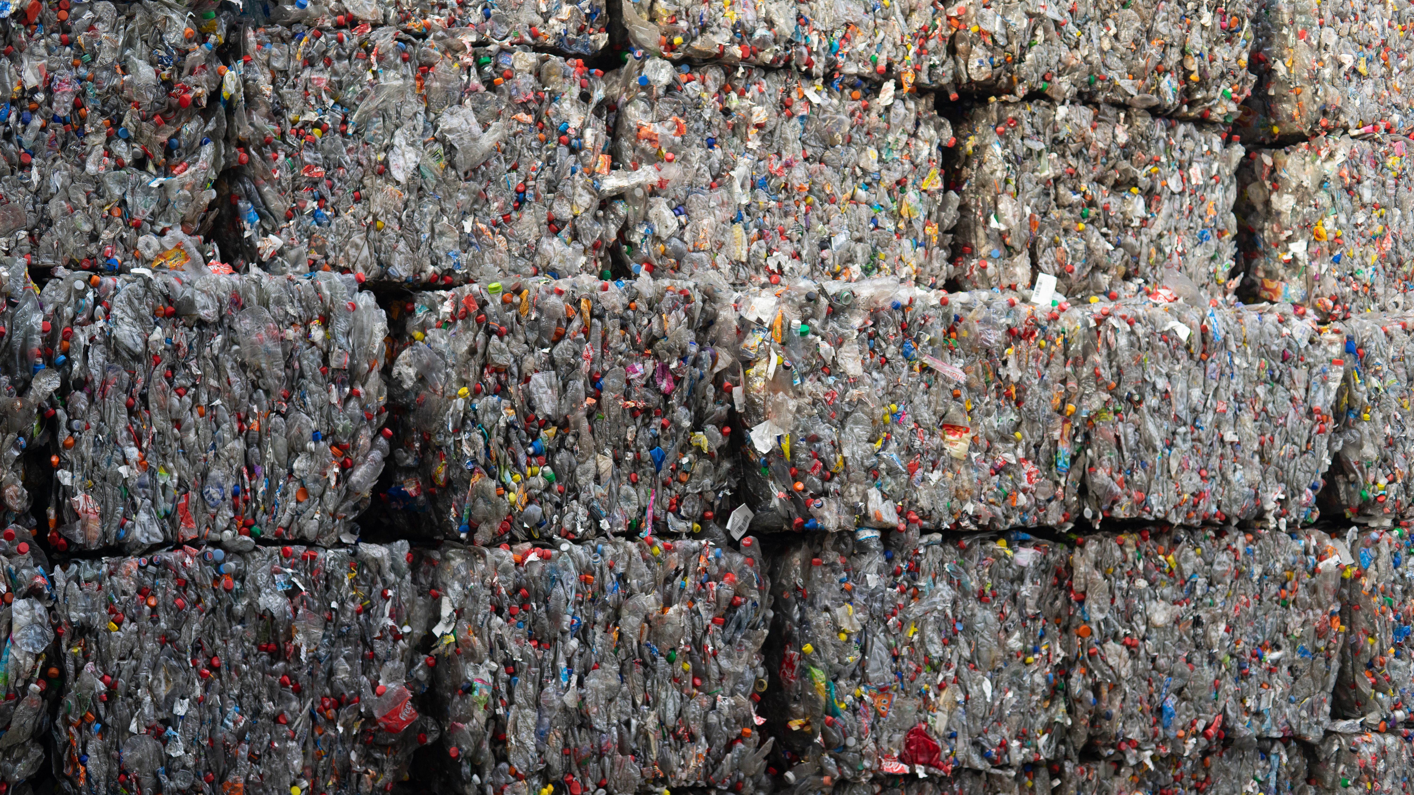 Compressed plastic bottle bales at a recycling centre, the raw material for De Vorm PET felt production