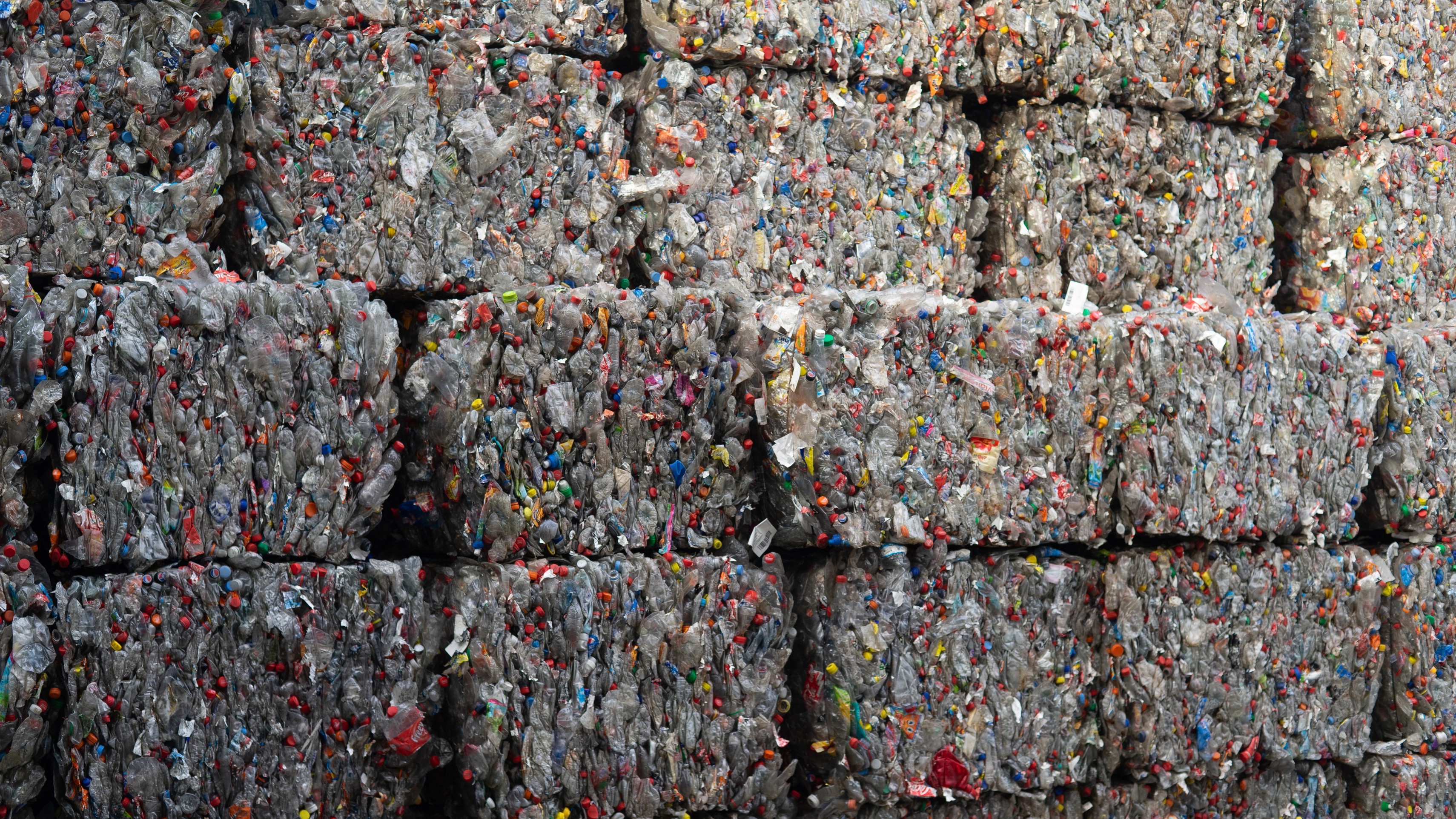 Compressed plastic bottle bales at a recycling centre, the raw material for De Vorm PET felt production