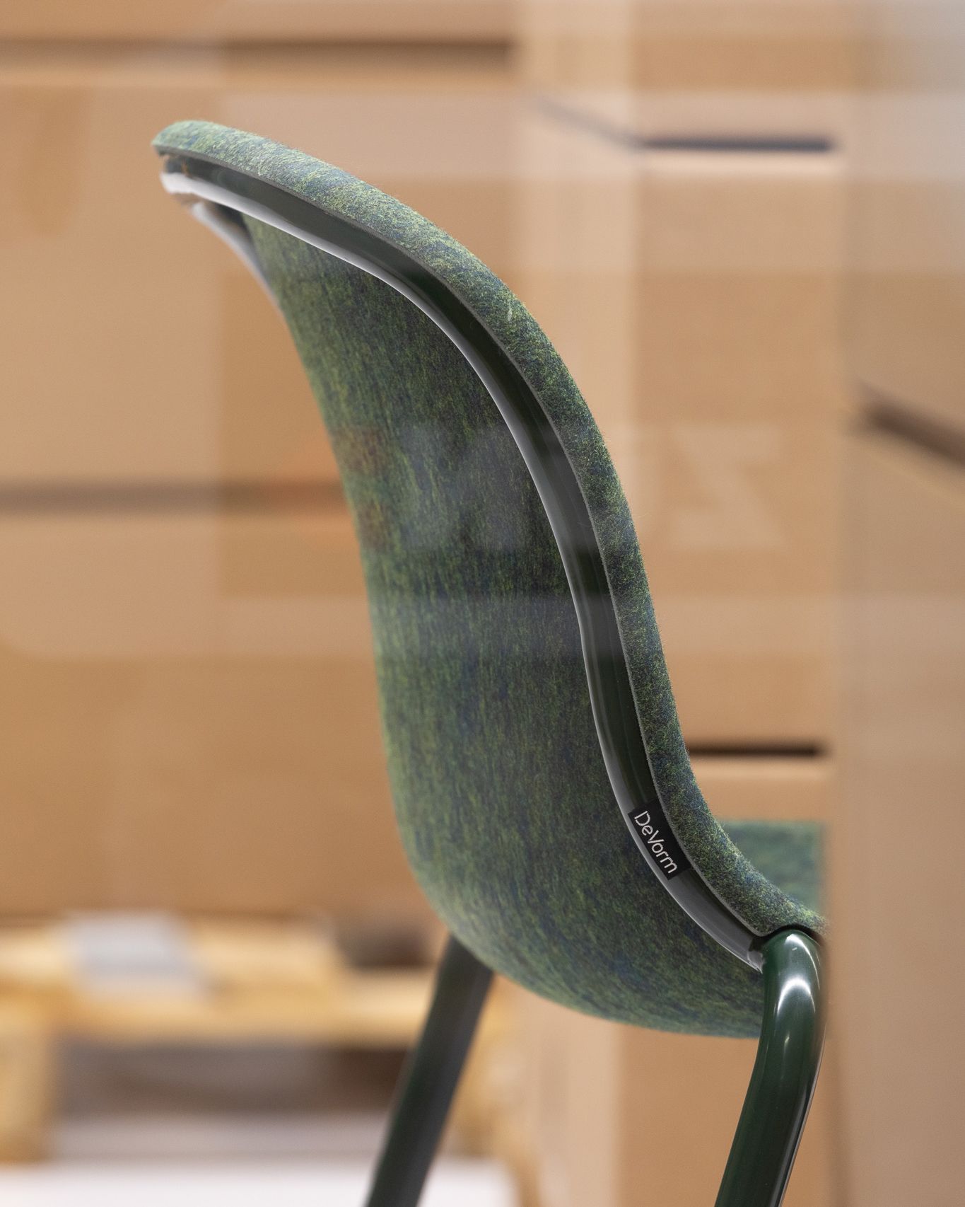 LJ 2 PET Felt Stack Chair in olive green with dark green frame, close-up of backrest in a warehouse setting