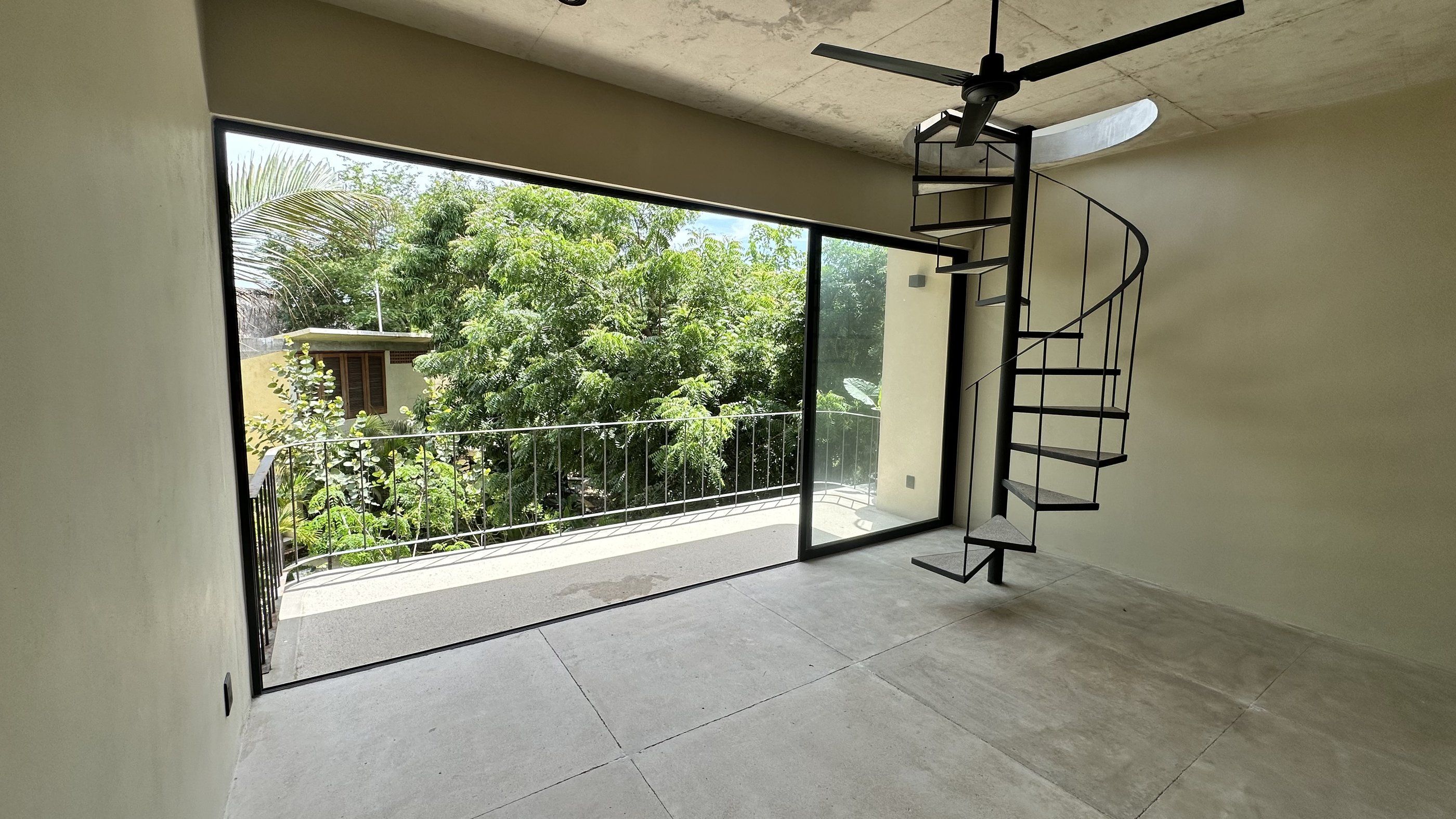 Studio lower level with spiral staircase and balcony