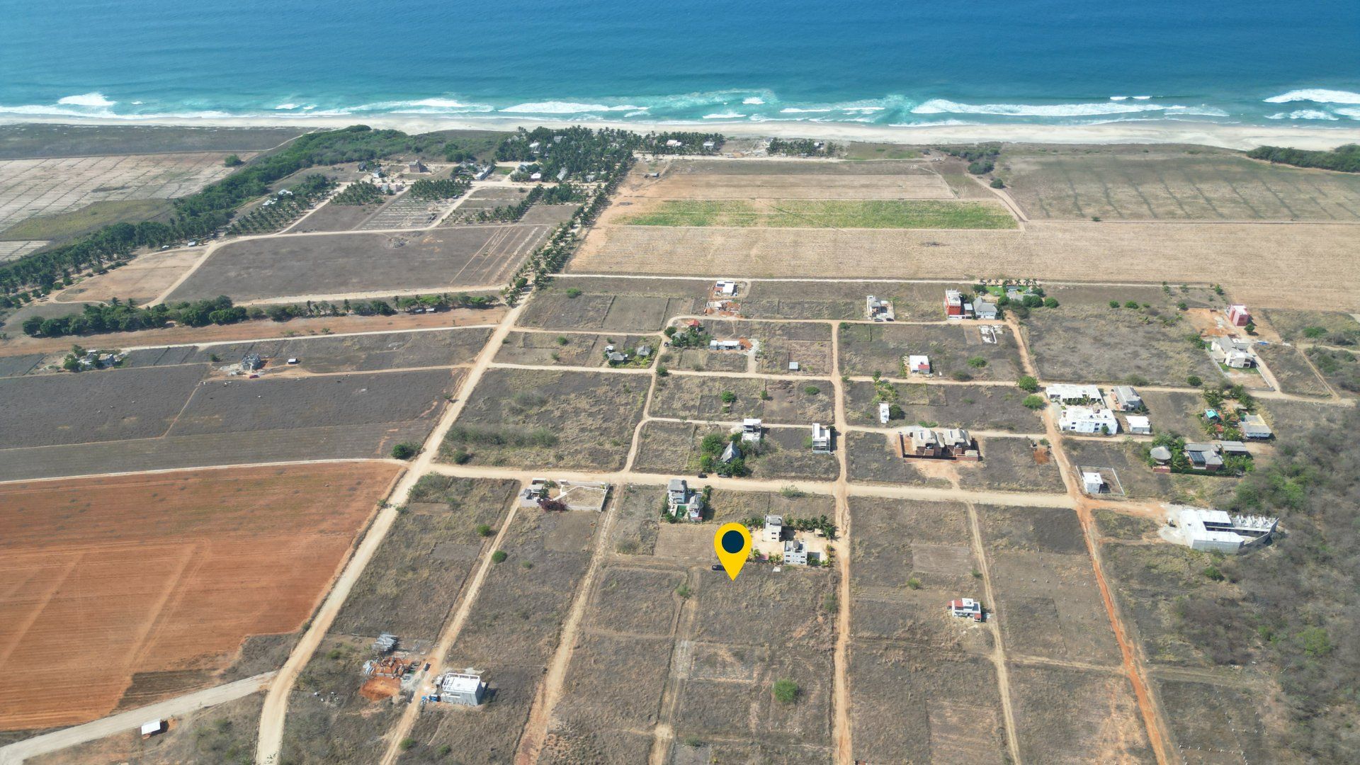 Drone view of the neighbourhood toward the beach, Tierra Blanca