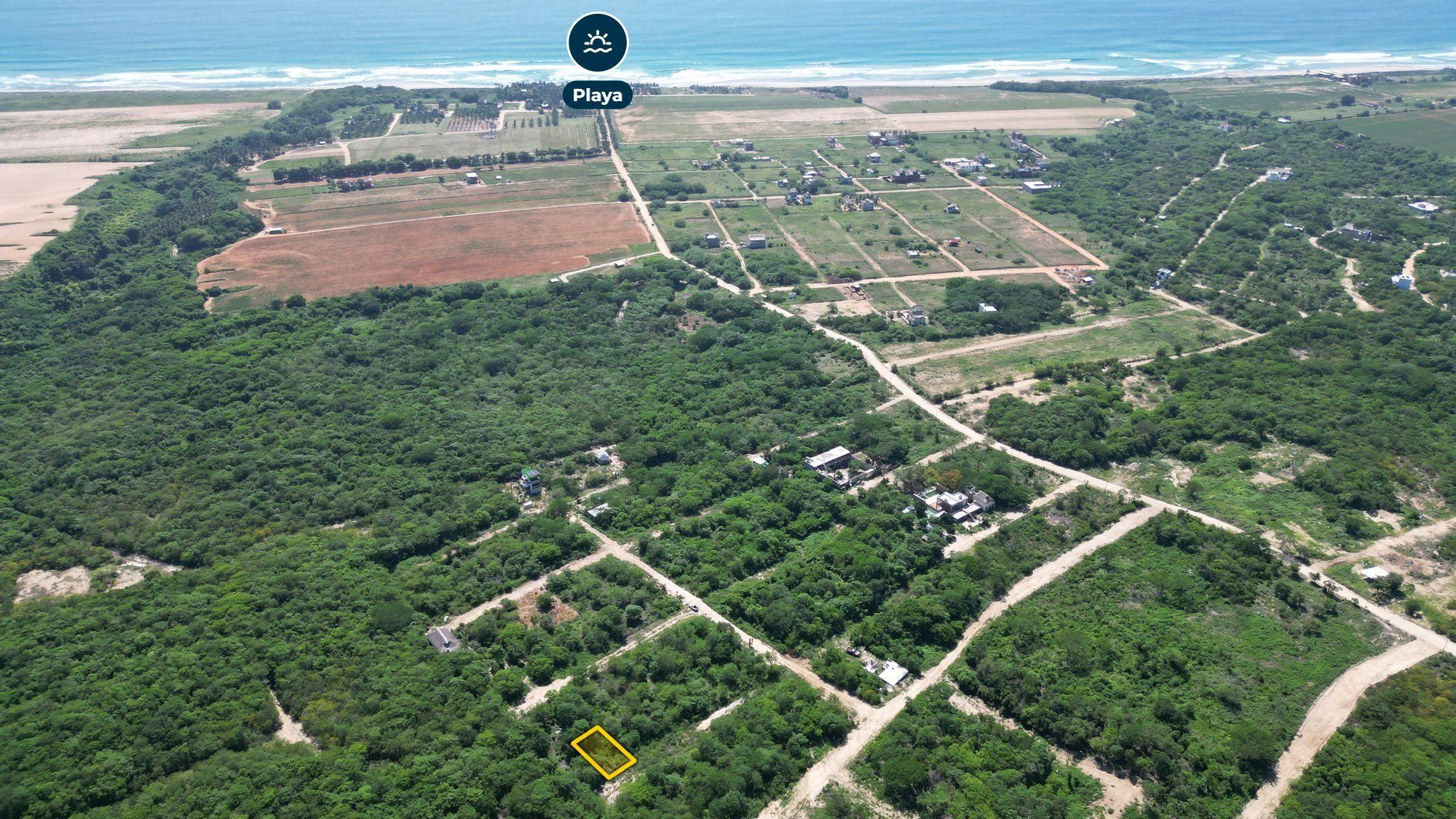 Drone view of the wooded development toward the beach, Tierra Blanca