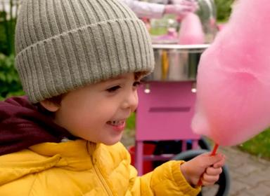 Smiling child holding cotton candy
