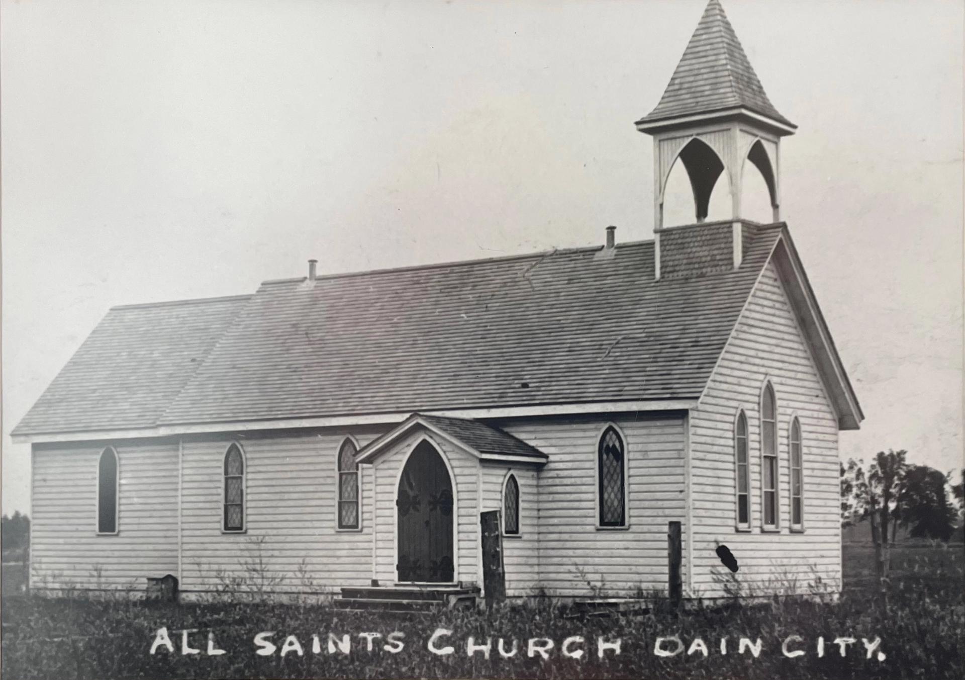 Old black and white photo of the original All Saints Church in Dain City